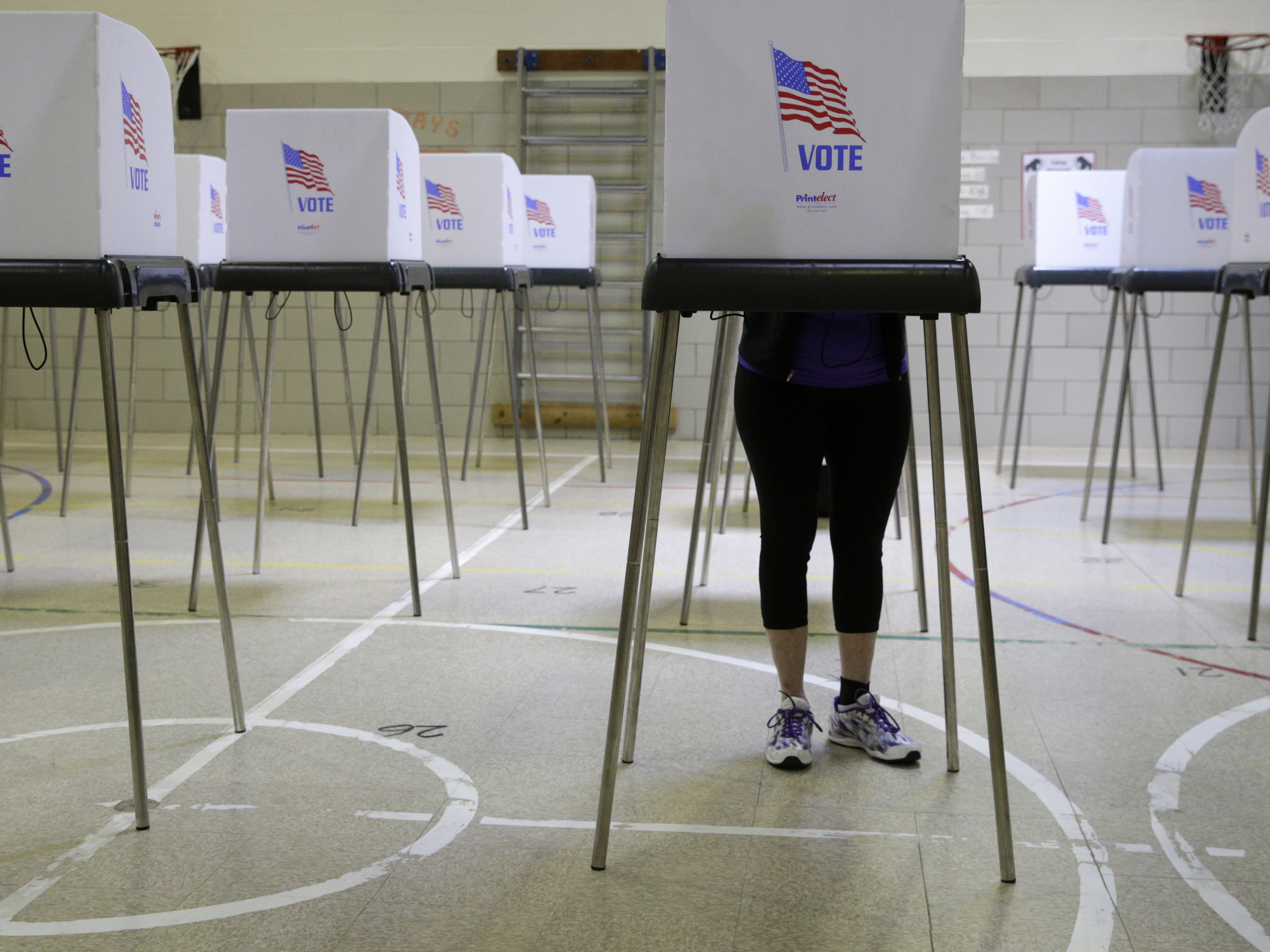 A woman casts her vote at a polling place inside Winfield Elementary School's gym in Windsor Mill, Md., during the state's 2016 primary. (AP)