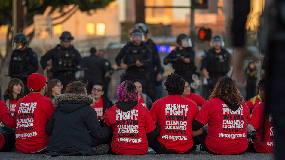 Police surround McDonald's restaurant employees who were sitting in an intersection in Los Angeles after walking off the job to demand a $15 minimum wage and union rights during nationwide "Fight for $15" protests on Tuesday. (David McNew/Getty Images)