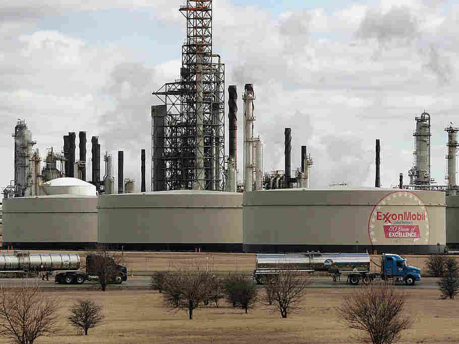 Tanker trucks drive past an ExxonMobil oil refinery on March 8, 2005, in Joliet, Ill.