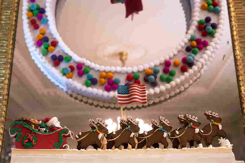 The top of the White House Gingerbread House features Santa in his sleigh with his reindeer leading the way.
