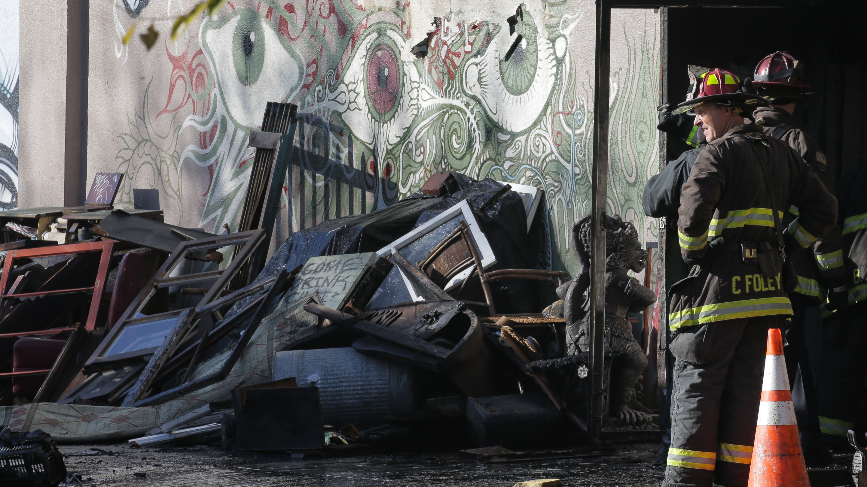 A collapsed roof and debris slowed down the recovery efforts of firefighters on Dec. 3 following a fire that killed at least 30 people at a warehouse in Oakland, Calif. (Getty Images)