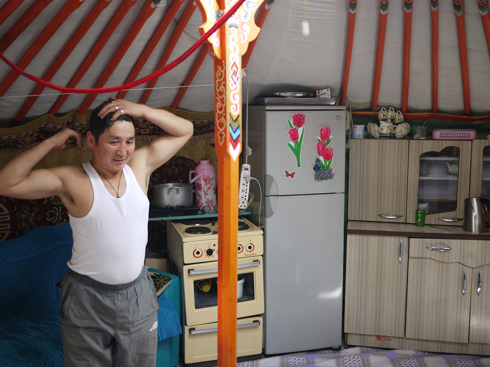 Gankhuyag, a former nomadic herder who now works in Ulaanbaatar as a porter, stands inside his ger on the outskirts of town. Rob Schmitz/NPR