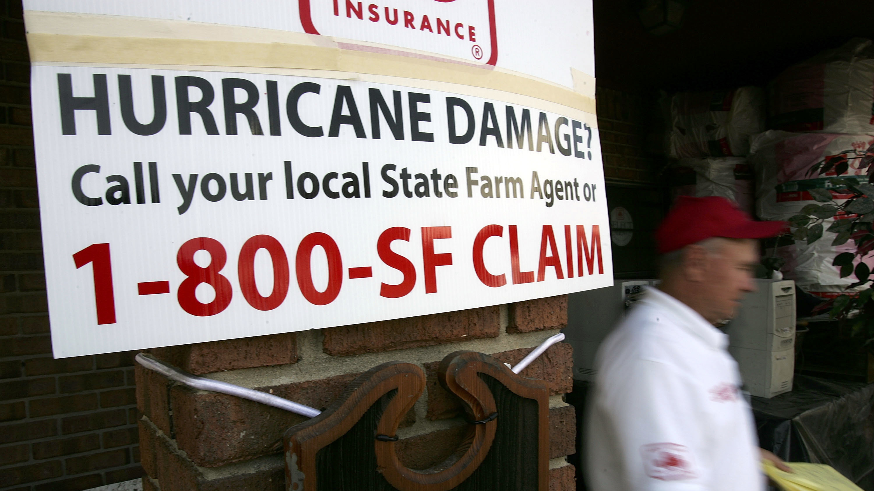 A banner for State Farm insurance in in D`Iberville, Miss., tells property owners the number to call after Hurricane Katrina hit in 2005. (Getty Images)