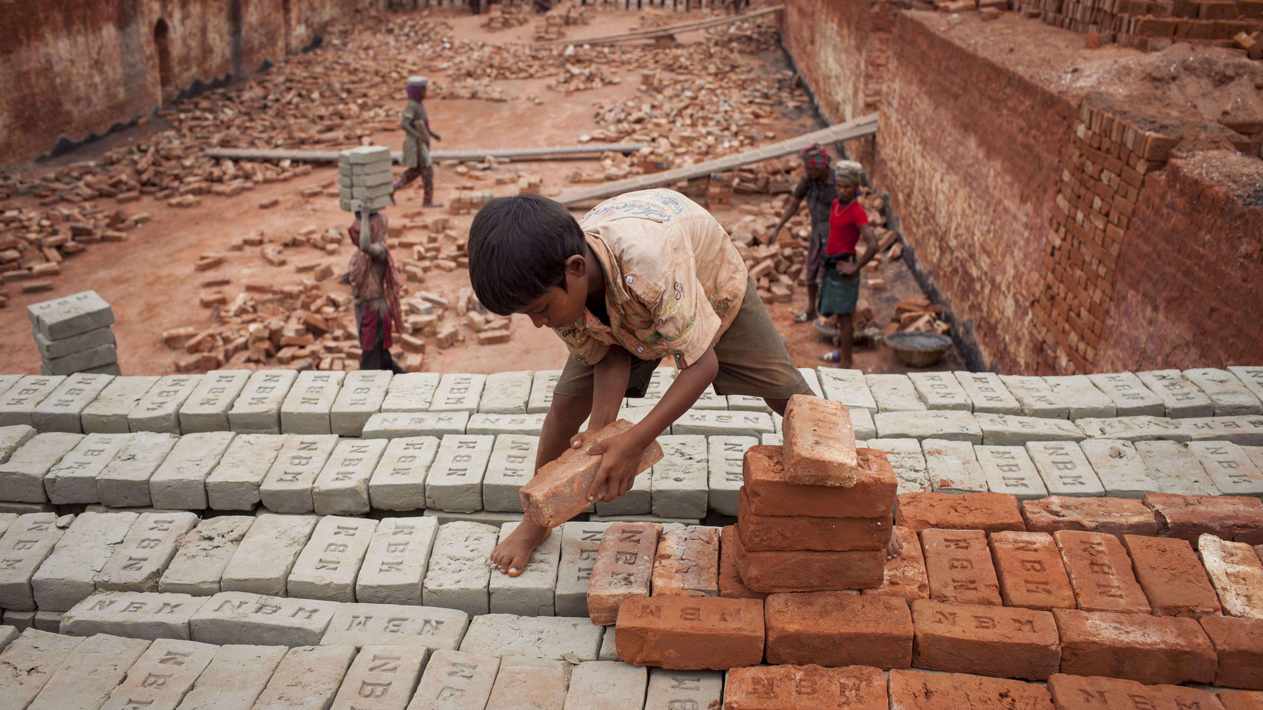 Babu, 8, works at a brick factory in Narayanganj, Bangladesh. (LightRocket via Getty Images)