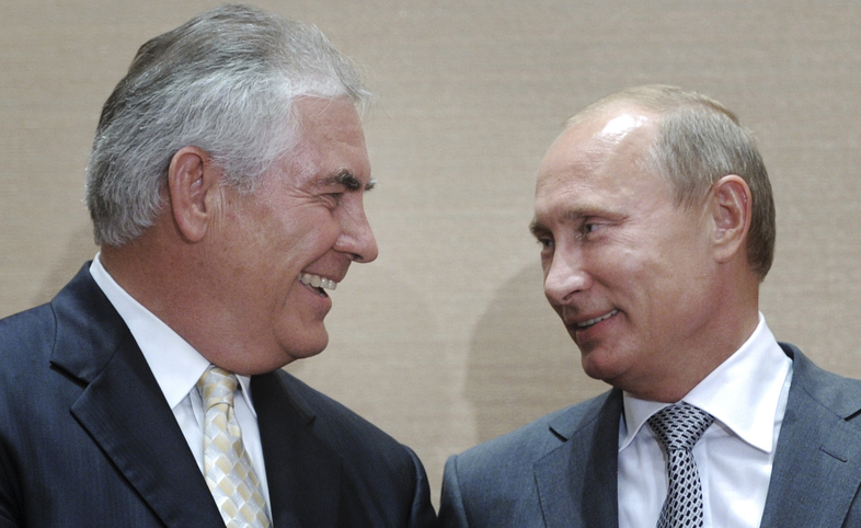 Russian leader Vladimir Putin (right), and Rex Tillerson, the head of ExxonMobil, smile during a signing ceremony for an oil agreement in Sochi, Russia, in 2011. Tillerson is widely reported to be President-elect Donald Trump's favored choice for secretary of state. U.S. policy toward Moscow used to be a unifying issue among Republicans and Democrats, but now it's a source of division. (Alexei Druzhinin/AP)