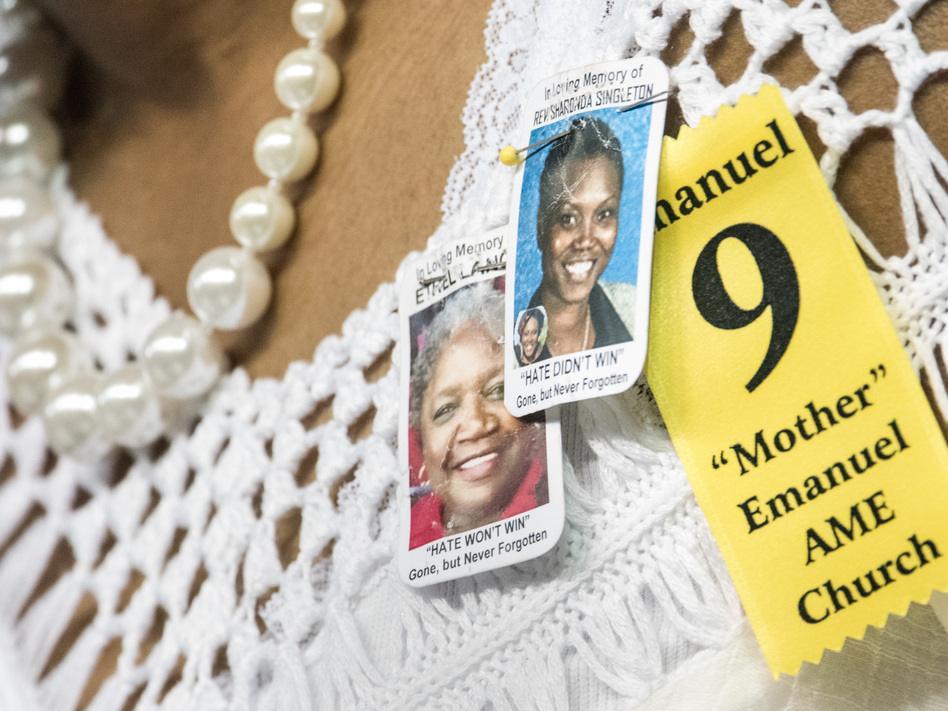 A woman at a memorial service wears tributes to two of the nine people murdered at Charleston's Emanuel African Methodist Episcopal Church, Sharonda Singleton and Ethel Lance. (Sean Rayford/Getty Images)