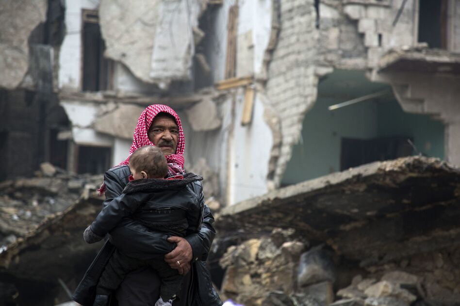Syrians leave a rebel-held area of Aleppo toward the government-held side on Tuesday, during an operation by Syrian government forces to retake the embattled city. U.N. chief Ban Ki-moon expressed alarm over reports of atrocities against civilians Monday, as the battle for Aleppo entered its final phase. (Karam al-Masri/AFP/Getty Images)
