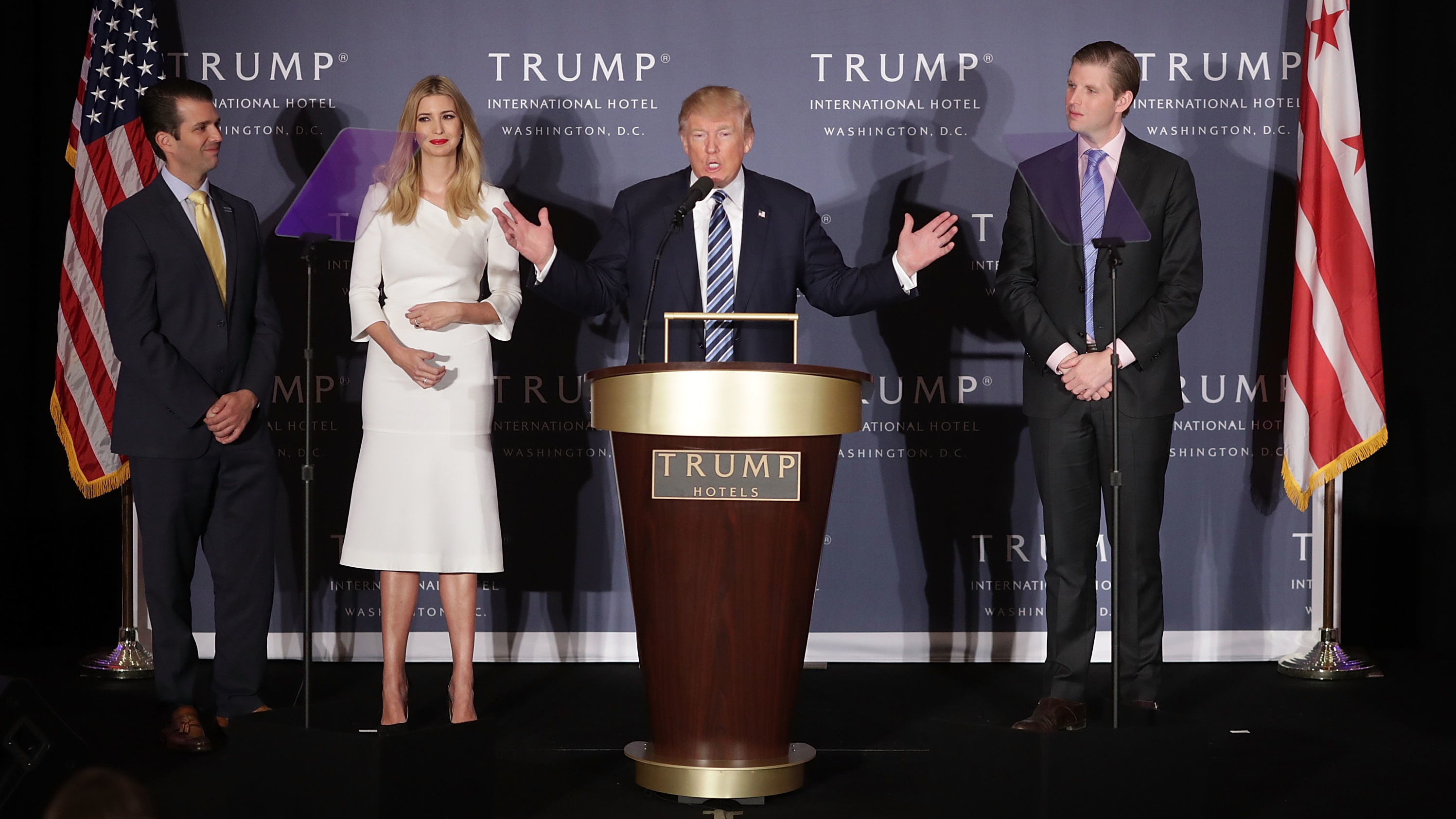 Donald Trump with his eldest children at the grand opening of the Trump International Hotel in Washington, D.C. Trump says he'll turn over control of his businesses to sons Eric and Donald Jr. (Getty Images)