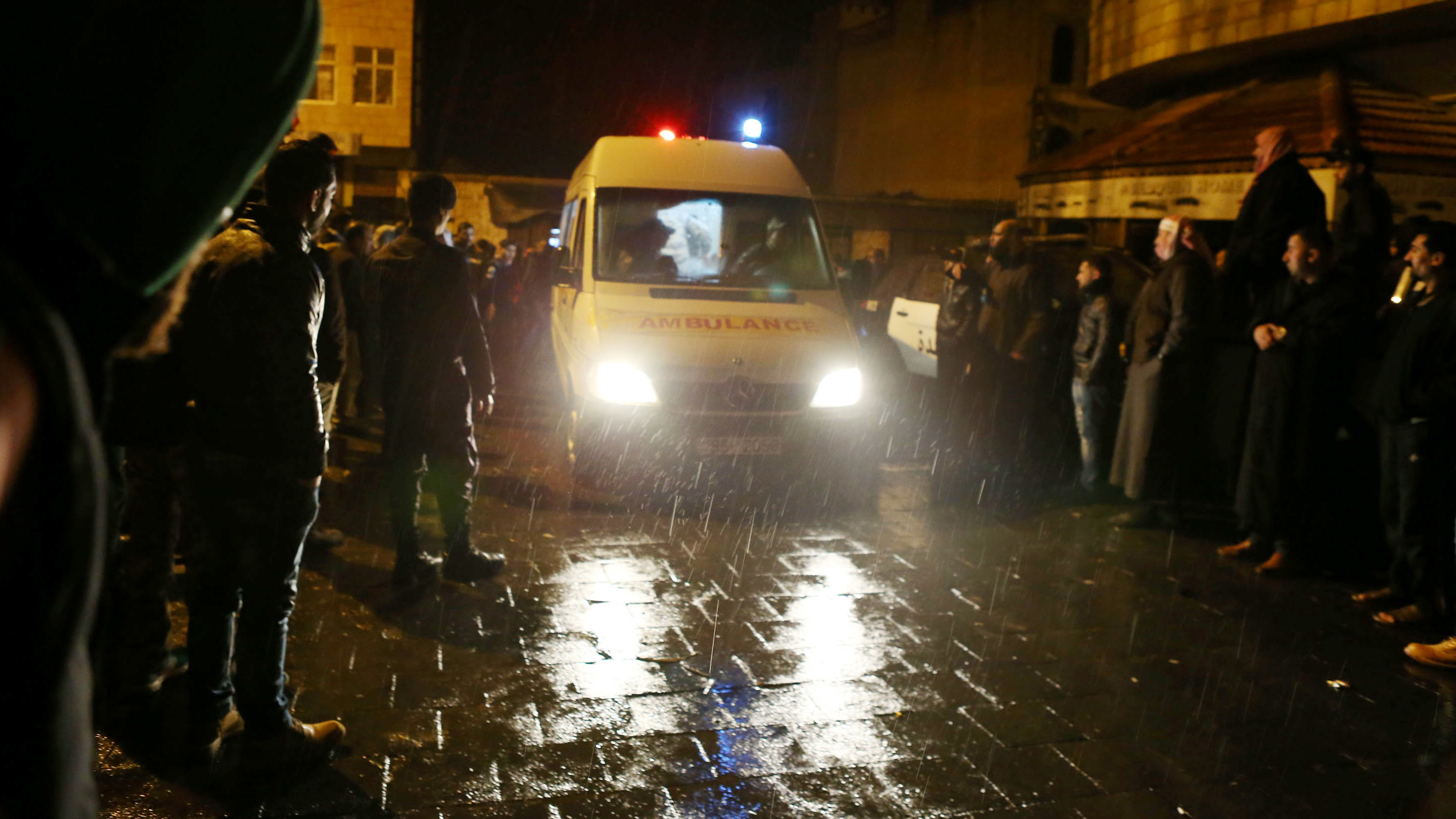 An ambulance leaves the scene following a gun attack in Karak, Jordan, Sunday. A Canadian tourist is among at least 10 people who died in a shootout between police and gunmen. (Getty Images)