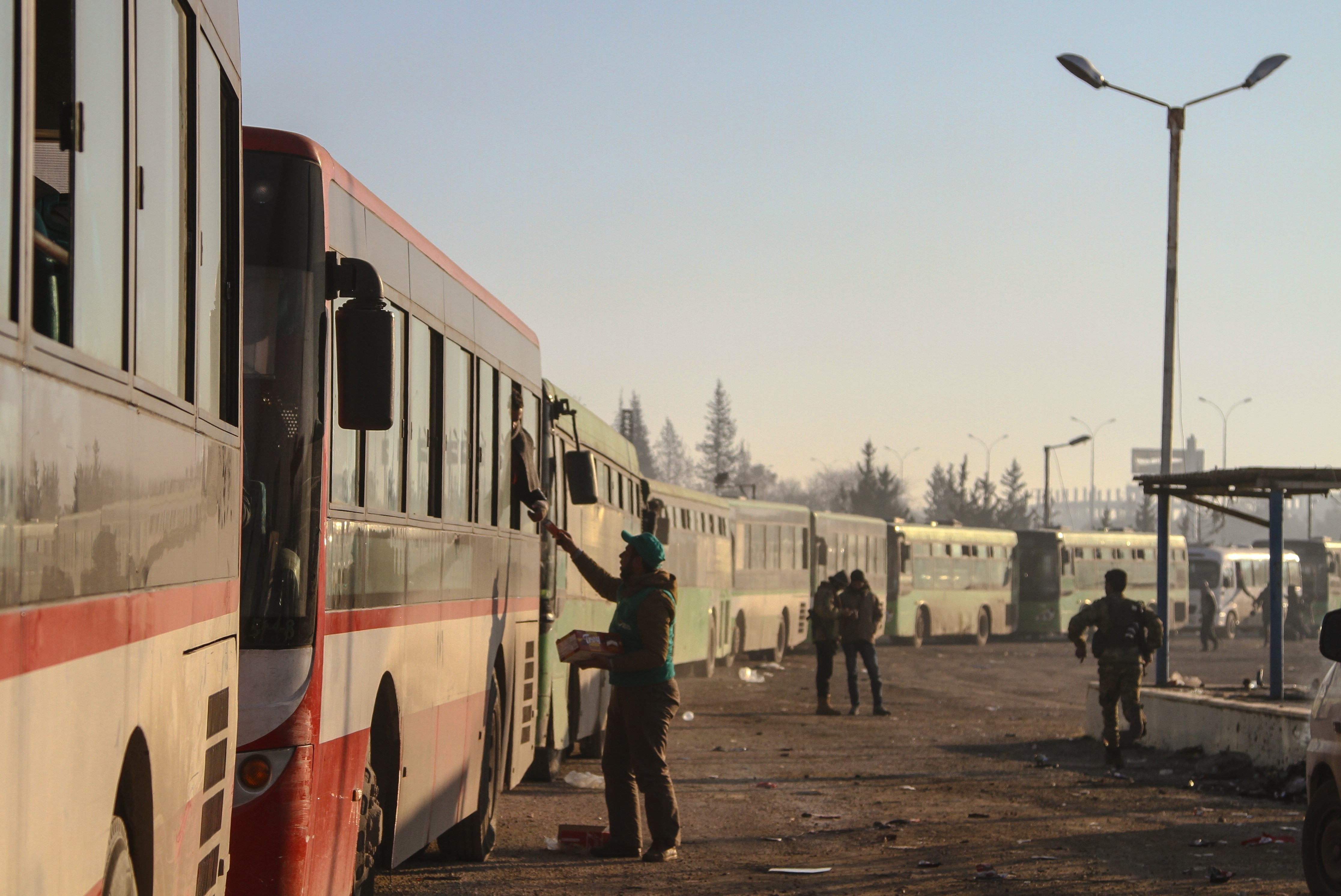 Civilians evacuated from east Aleppo arrive in Syria's Rashidin region on Monday. A series of cease-fire and evacuation deals have been negotiated, broken and renegotiated over the past few days. (Getty Images)