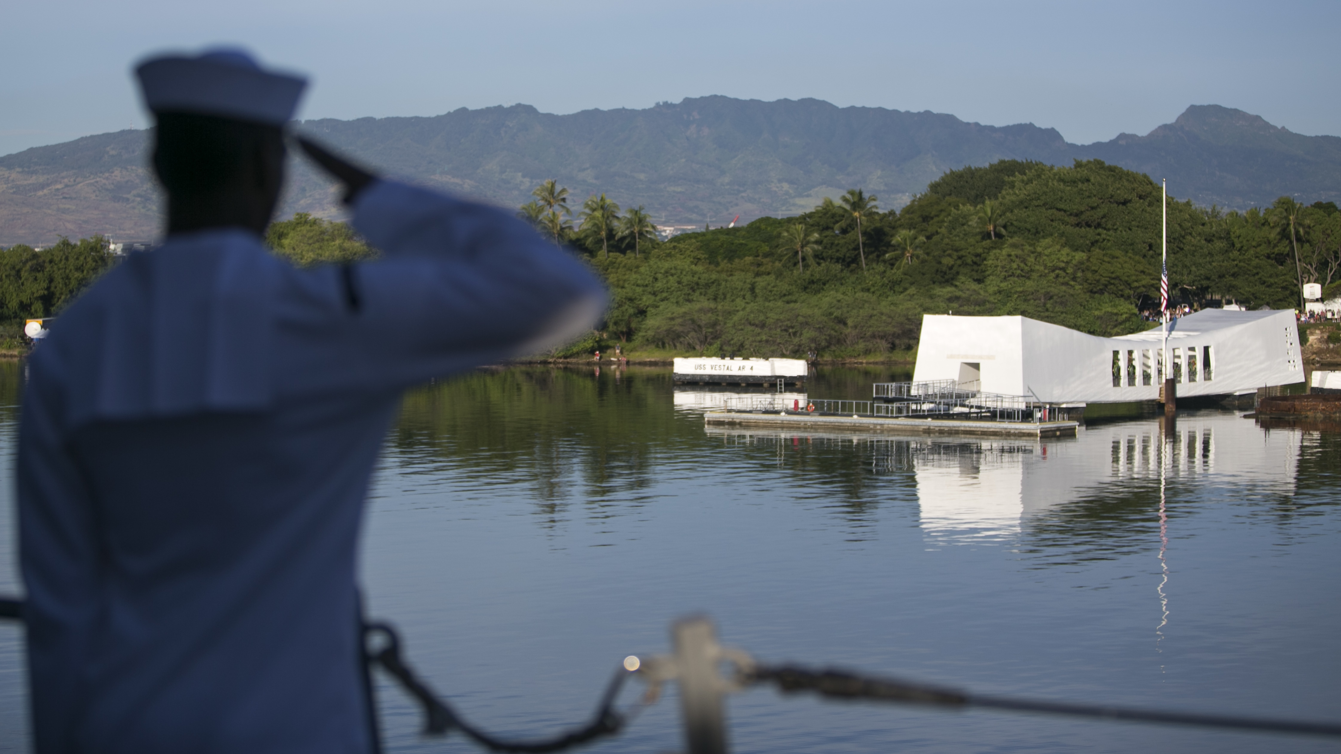 A Navy sailor salutes the memorial to the USS Arizona on Dec. 7, the 75th anniversary of the Japanese attack on Pearl Harbor. The Arizona was hit in the air raid.