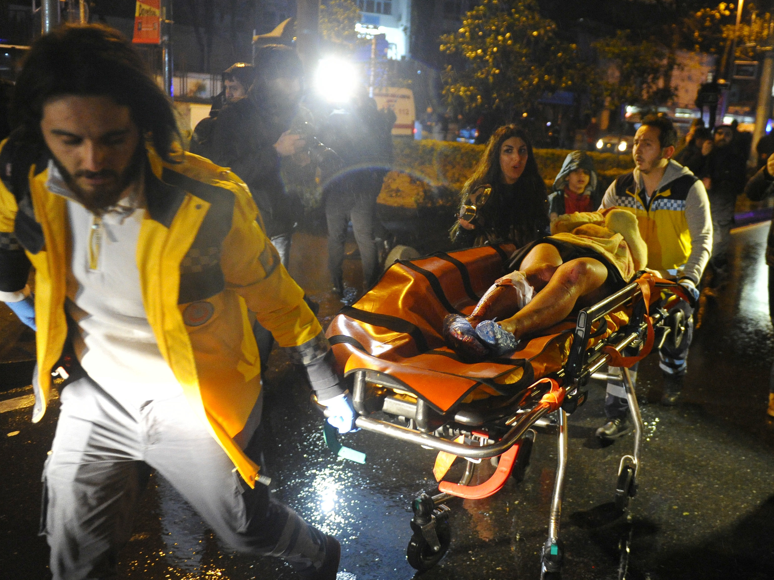 First aid officers carry an injured woman at the site of an armed attack on Sunday in Istanbul. At least 39 people were killed in an armed attack Saturday on an Istanbul nightclub where people were celebrating the new year. (AFP/Getty Images)