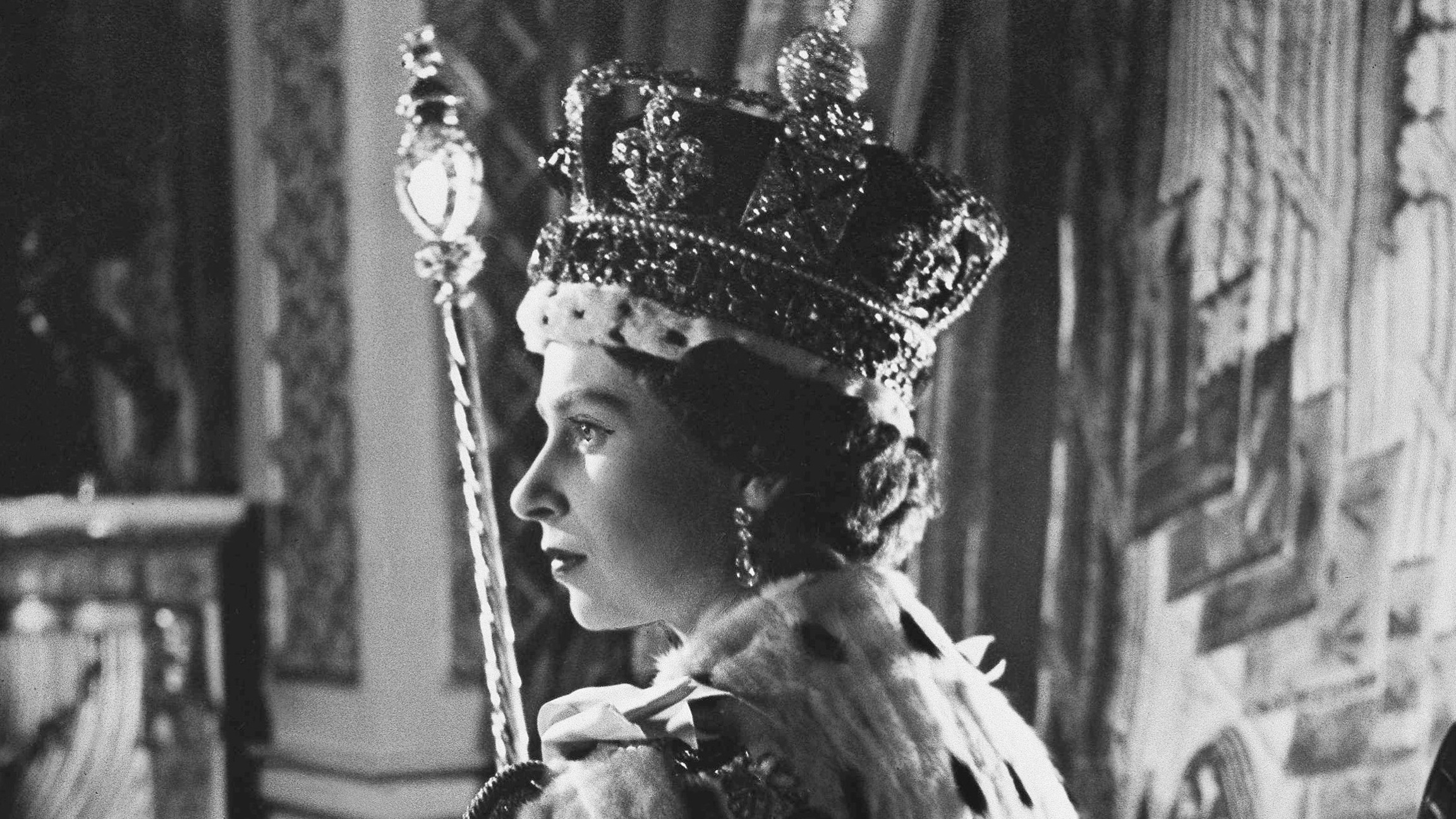Queen Elizabeth II poses in her coronation attire in the throne room of Buckingham Palace in London, after her coronation on June 2, 1953.