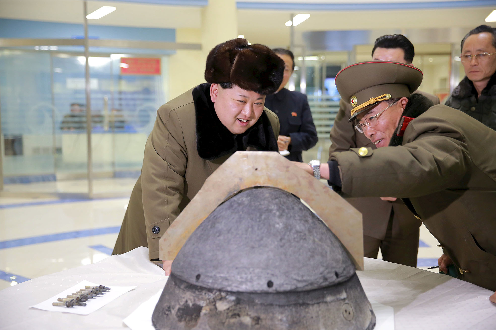 North Korean leader Kim Jong Un looks at a warhead component being developed for a ballistic missile, at an unidentified location in this undated photo released by North Korea's Korean Central News Agency on March 15, 2016. (Reuters)