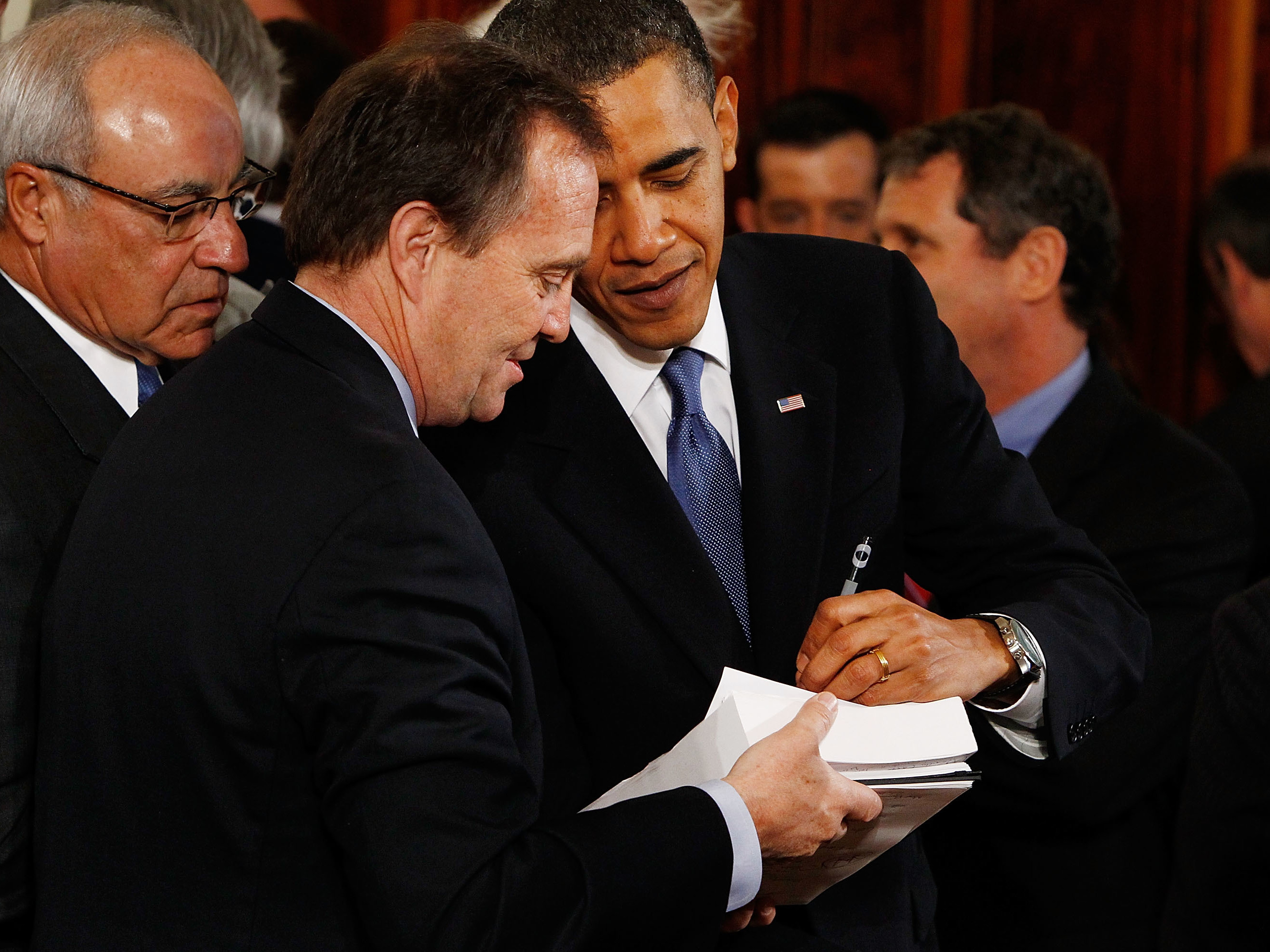 President Barack Obama signs a copy of the Affordable Health Care for America Act for a member of Congress after signing the acutual bill during a ceremony in the East Room of the White House March 23, 2010 in Washington, DC. (Chip Somodevilla/Getty Images)