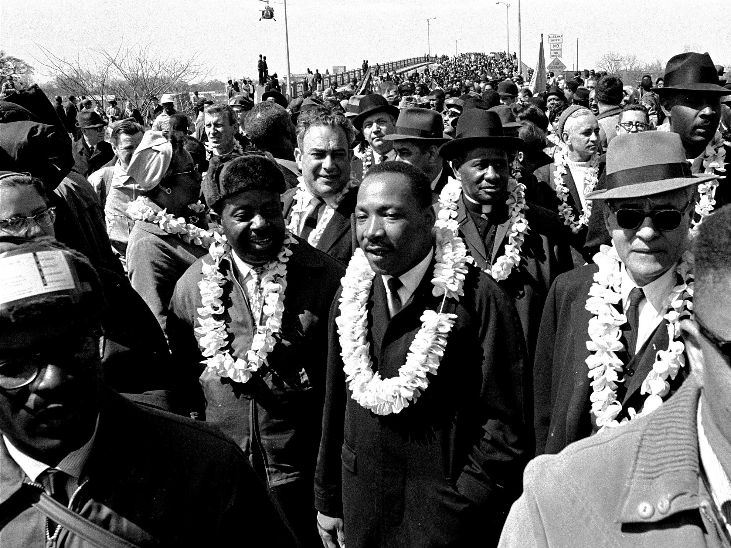 The nonviolent actions of Dr. King inspired young Kennedy Odede. In this March 21, 1965 file photo, King leads a civil rights march across the Edmund Pettus Bridge in Selma, Ala., to protest voting laws. (AP)