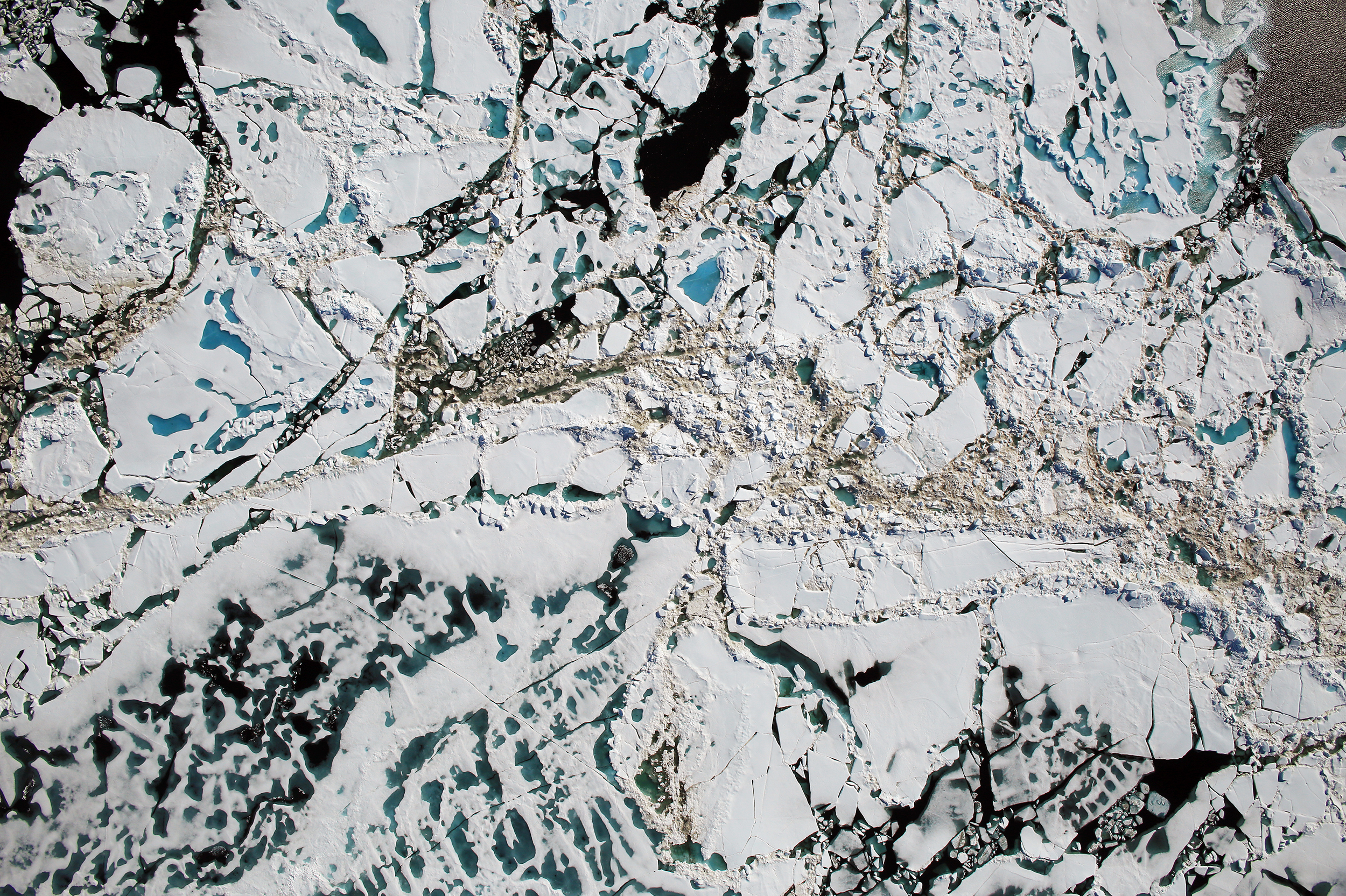 Chunks of Arctic sea ice, melt ponds and open water are all seen in this image captured by NASA's Digital Mapping System instrument during an Operation IceBridge flight over the Chukchi Sea in July 2016. Last year was particularly bad for Arctic sea ice. (NASA/Goddard/Operation IceBridge)