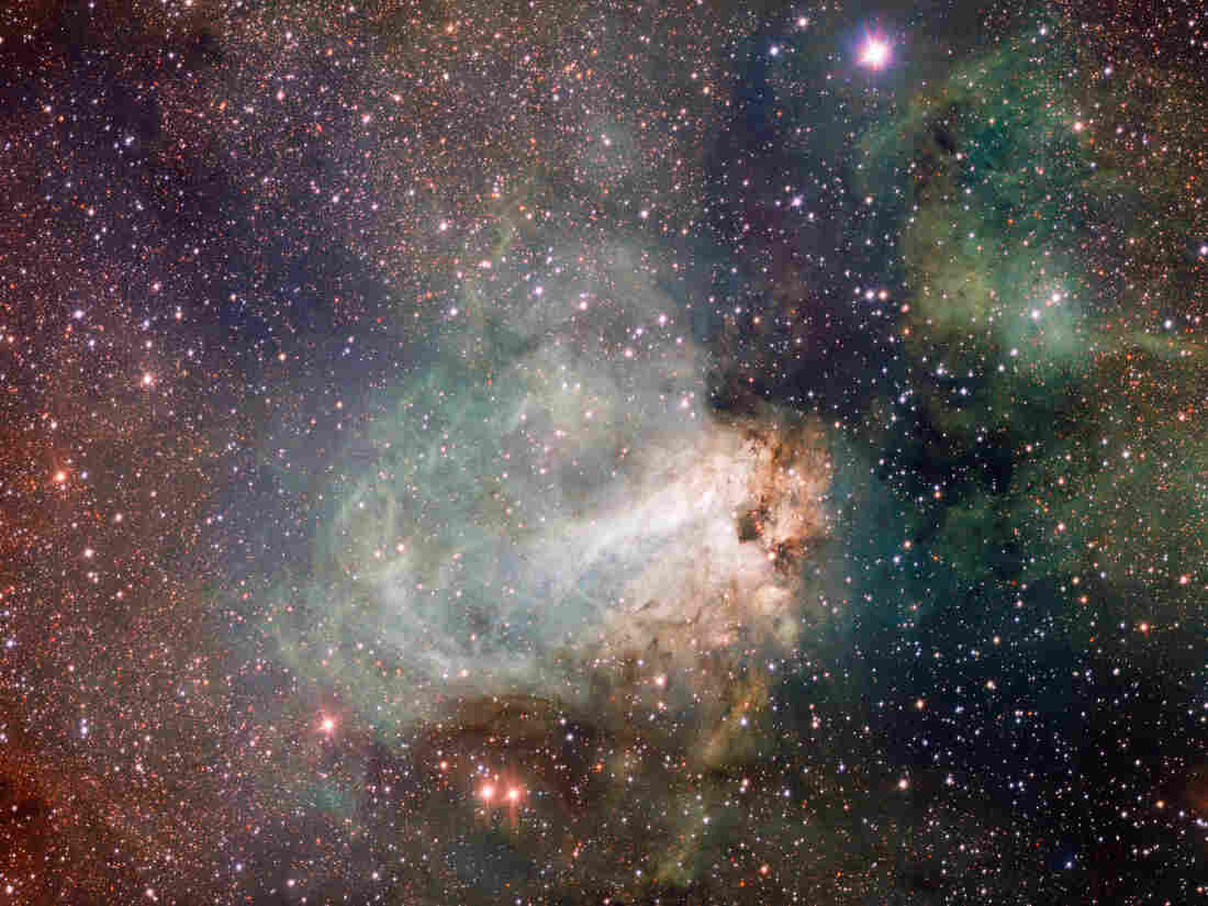 The star-forming region Messier 17, also known as the Omega Nebula or the Swan Nebula, is a vast area of gas, dust and hot young stars lying in the heart of the Milky Way in the constellation of Sagittarius.