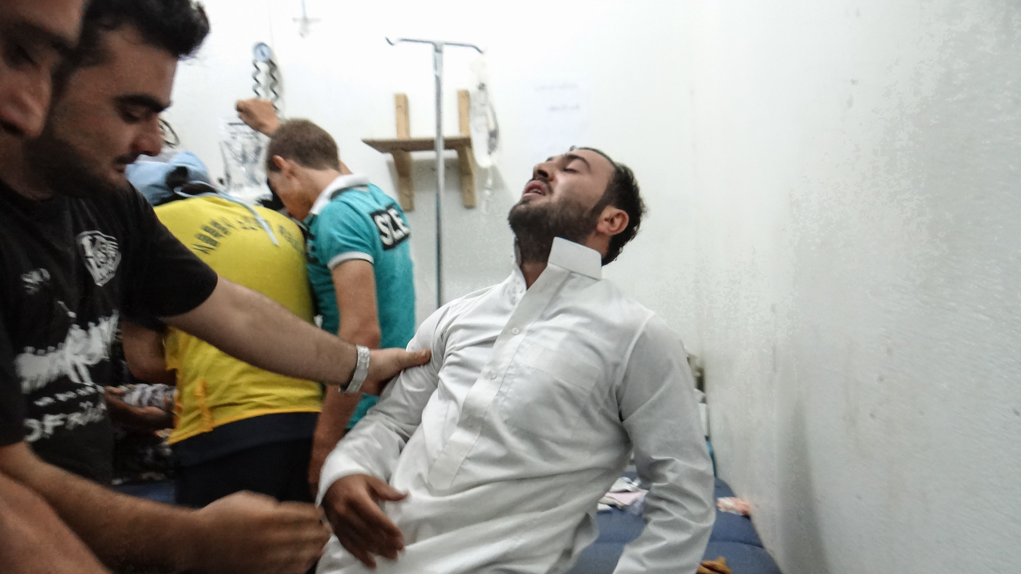 Health workers treat a man at a hospital in Idlib, Syria, about 40 miles from Aleppo.