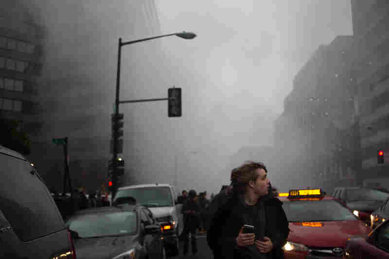 People run from smoke and fire that billows from near Franklin Square, where a limo was set on fire.