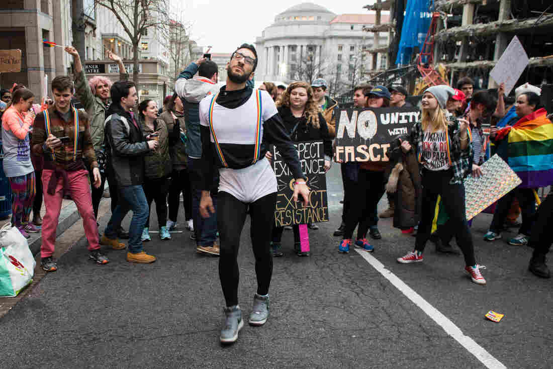 Firas Nasr dances amongst a group of LGBT-affiliated protesters as they block one of the entries to the presidential inauguration parade route.