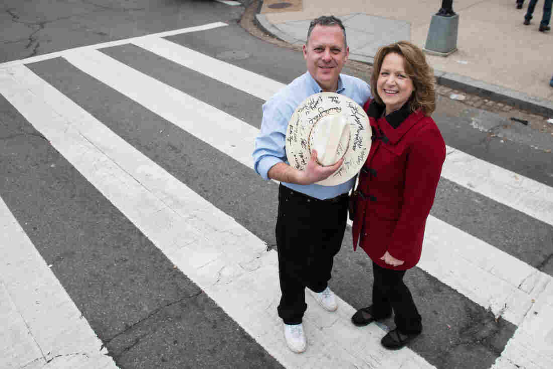Ken Crider and his wife, Penny, pose near the National Mall. Crider holds a hat signed by many important political figures including president Donald Trump.