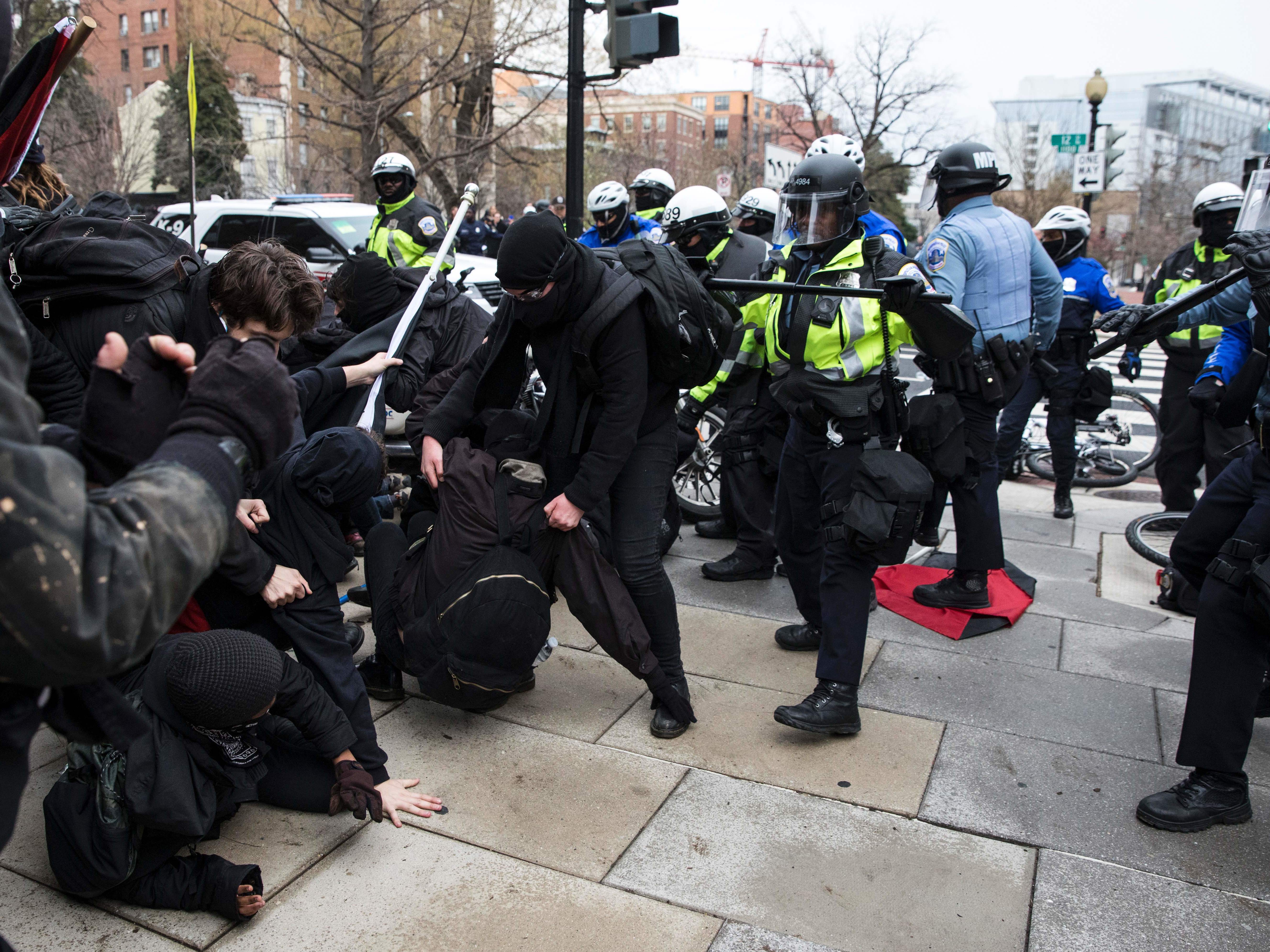 Police officers push a group of demonstrators back in Northwest Washington, D.C., on Friday. Violence broke out in the area among a crowd of several hundred, but the city's interim police chief says protests across the city have been largely peaceful. (AFP/Getty Images)