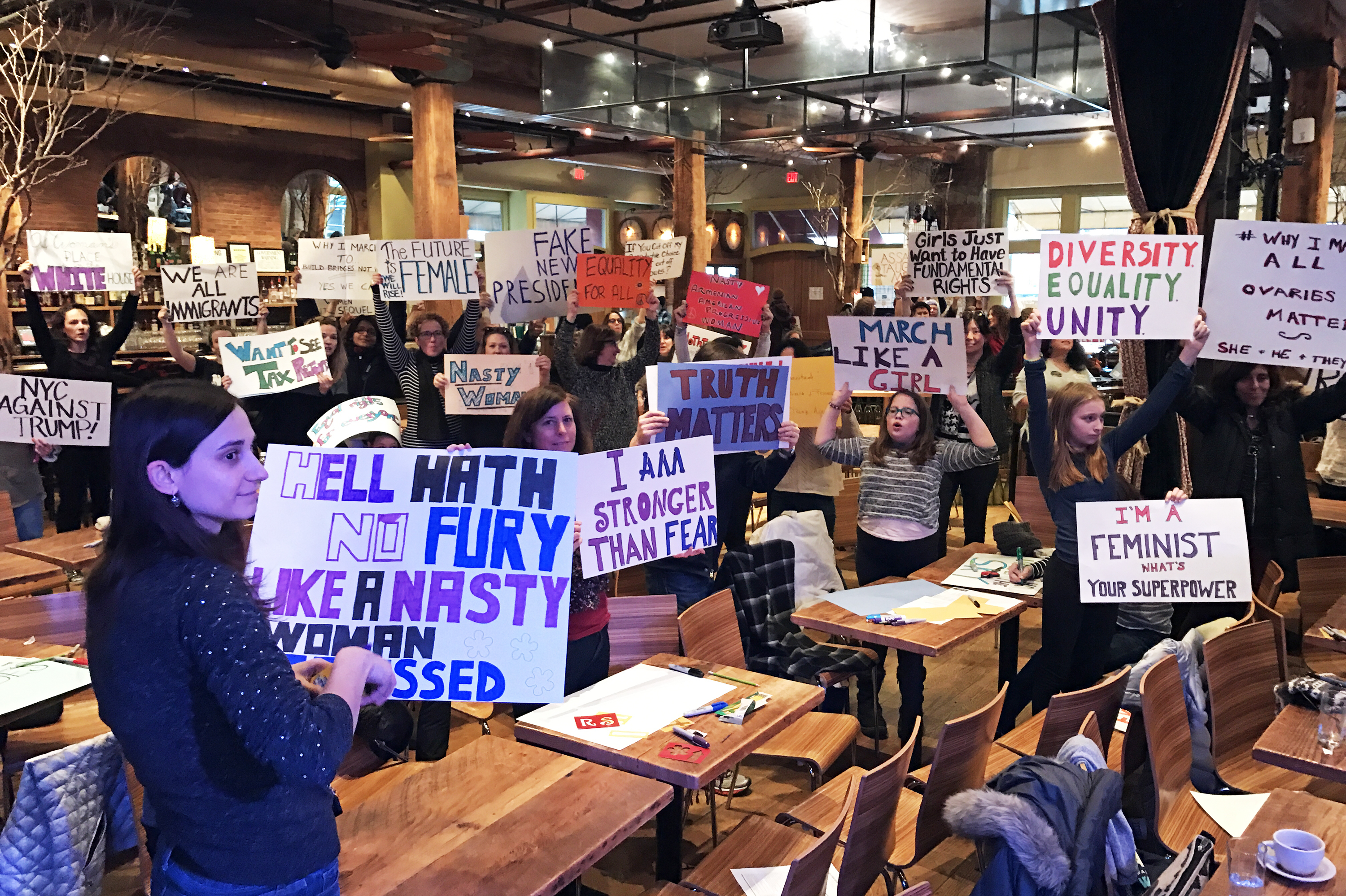 Protesters hold up their handmade signs as they prepare for the Women's March on Washington. (NPR)
