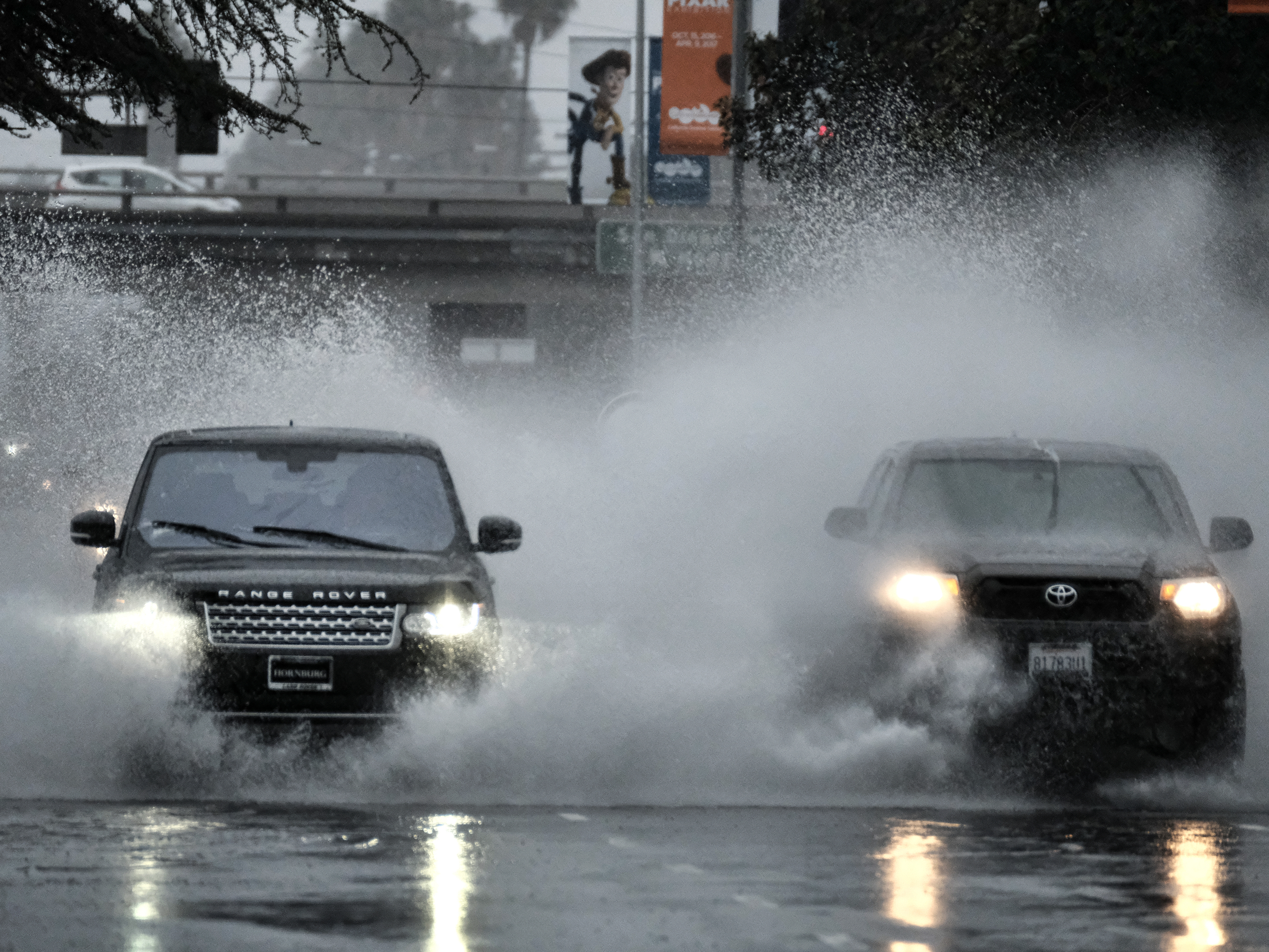 A flooded street in the Van Nuys section of Los Angeles on Sunday. Some California residents evacuated neighborhoods below hillsides scarred by wildfires, amid concerns about mudslides. (Richard Vogel/AP)