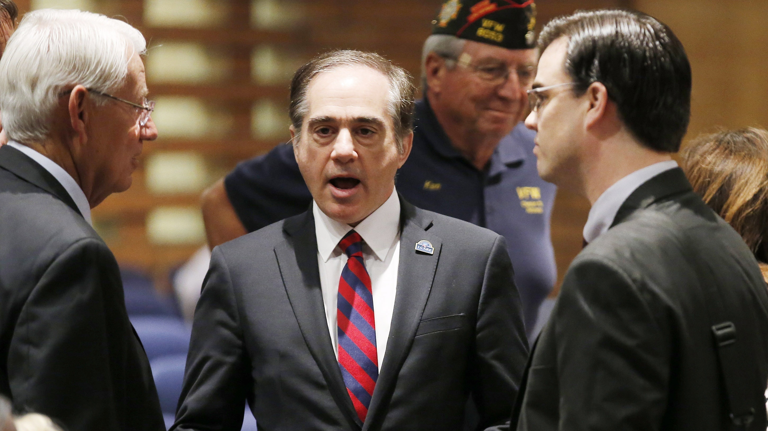 David Shulkin (center), the U.S. Department of Veterans Affairs undersecretary of health, talks with attendees in July prior to testifying at a Senate Veterans