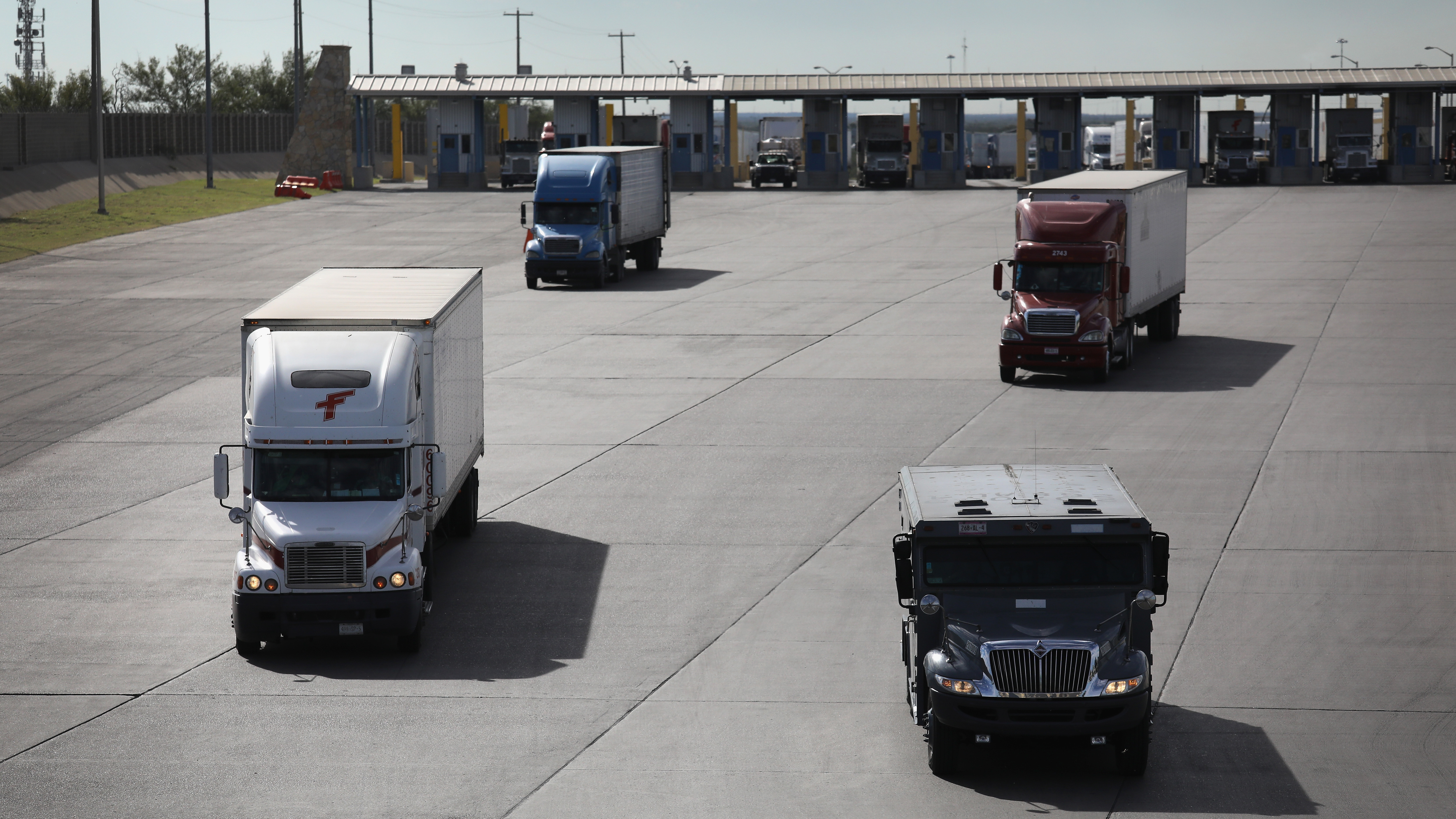 Trucks, including an armored car, pass through U.S. customs in 2016 in Laredo, Texas.