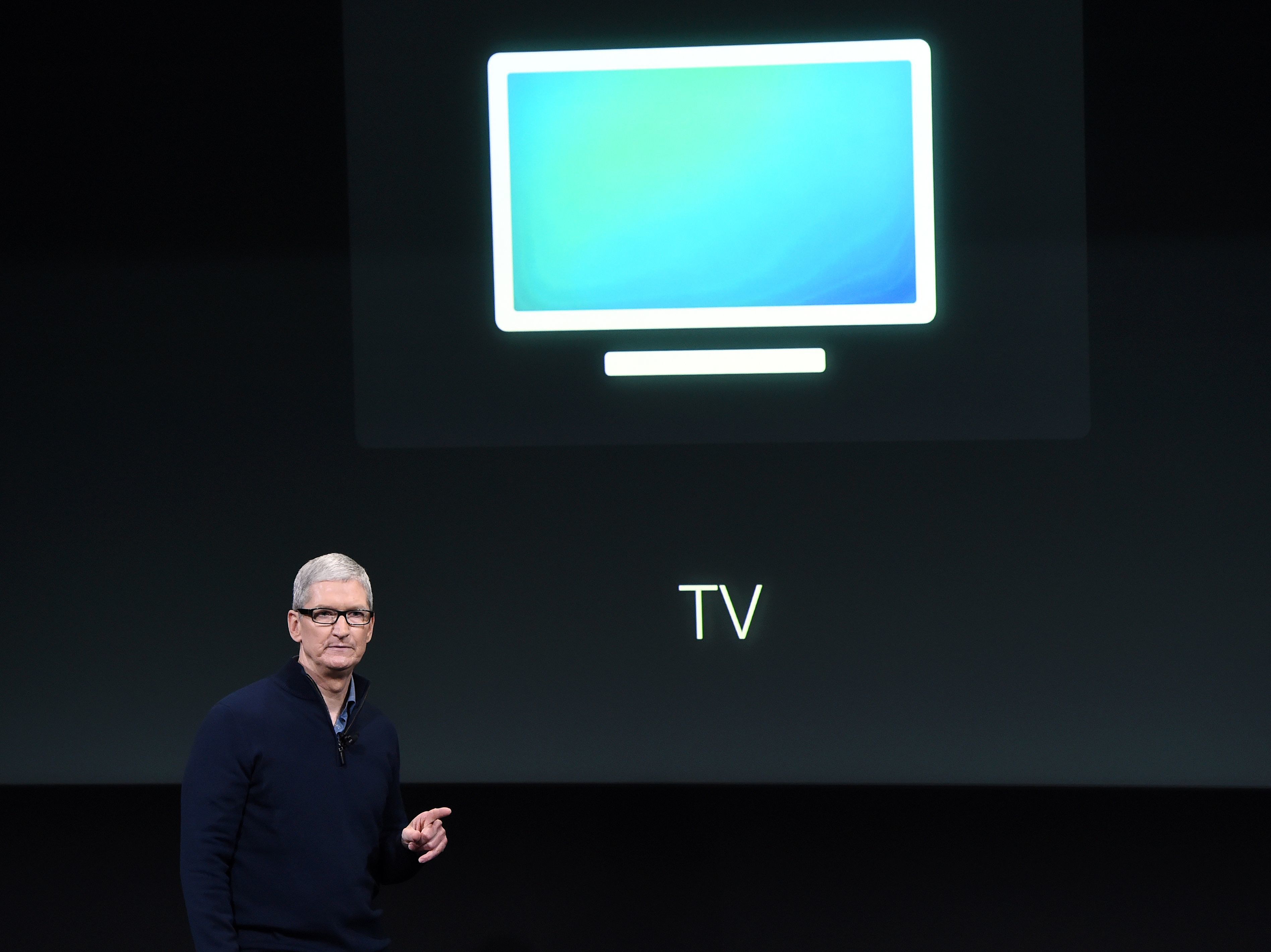 Apple CEO Tim Cook introduces the new Apple TV app during a product launch event in Cupertino, Calif., in October. The company now plans to make original movies and TV programming, according to sources. (AFP/Getty Images)