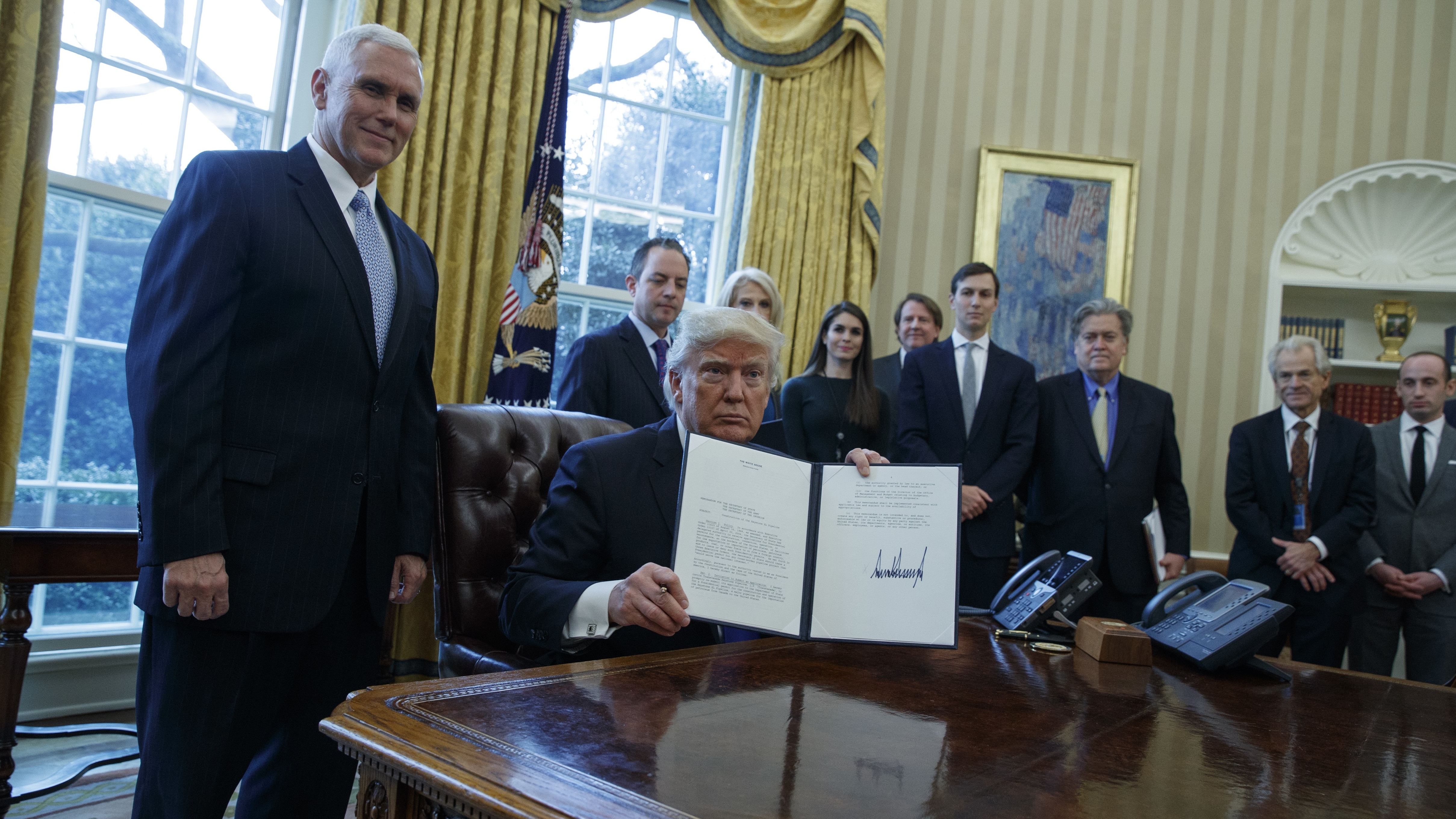 President Trump, accompanied by Vice President Pence and staff, signed multiple documents regarding two major oil pipelines in the U.S.