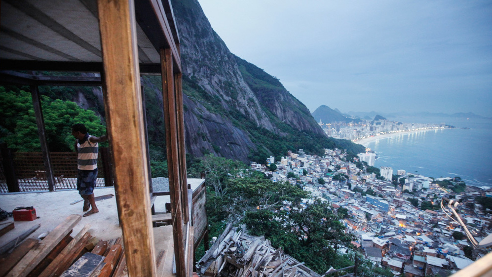 A worker stands in a construction project in a favela, or shantytown, in Rio de Janeiro, Brazil. The government has helped drive down income inequality by investing in basic services like health care, education and pensions.