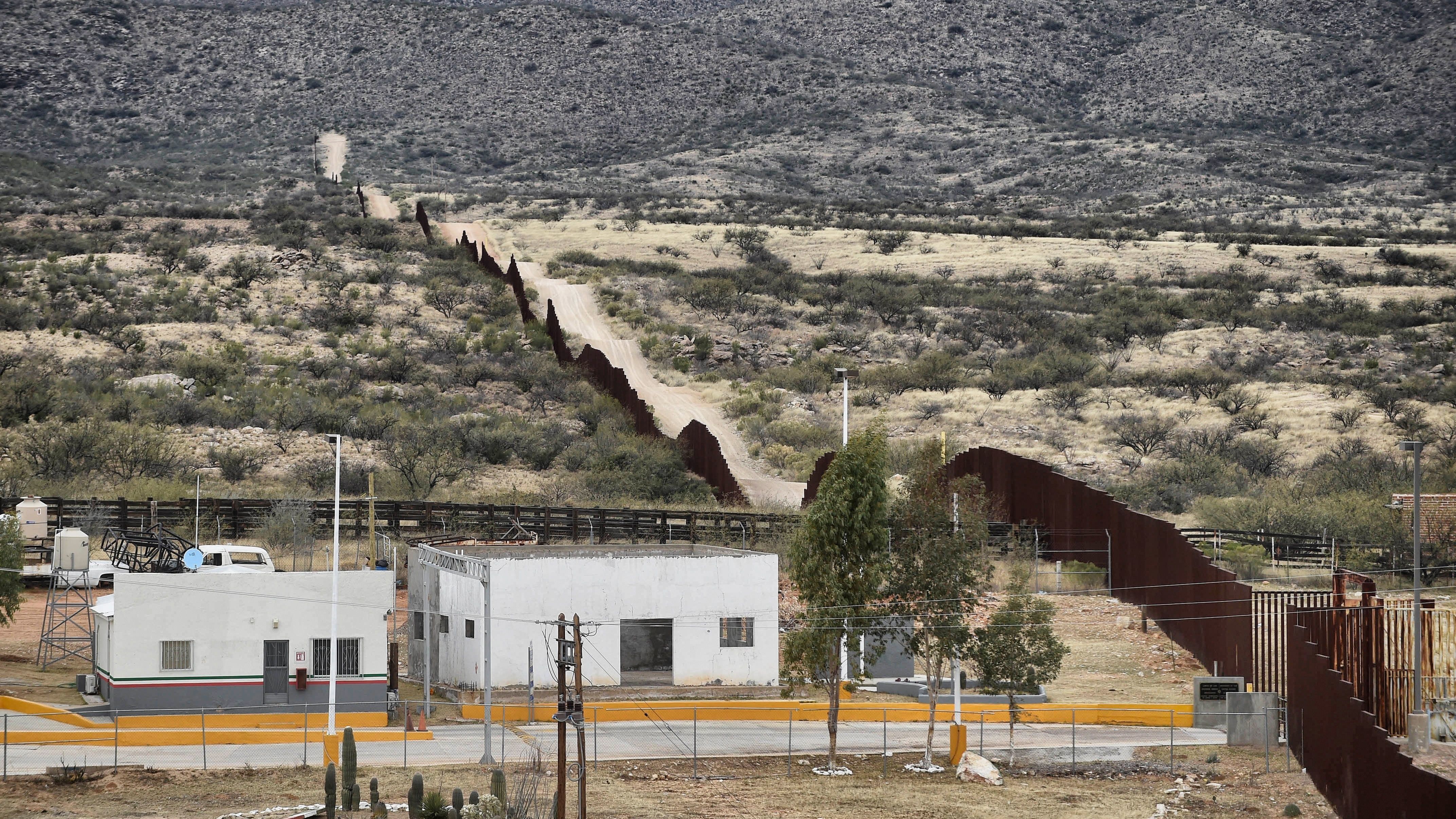 President Trump is expected Wednesday to sign an order to begin building a new wall along the border line between Mexico and the U.S. Here, the border is seen from the community of Sasabe in Sonora state, Mexico, earlier this month.