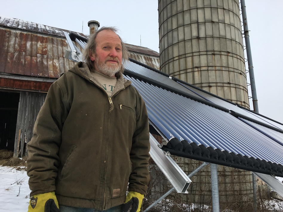 Rick Moore, a dairy farmer in Canton, N.Y., has a solar thermal array to heat water he uses to spray down milking equipment. (David Sommerstein/North Country Public Radio)