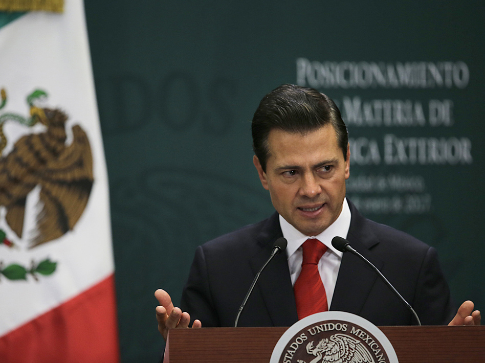 Mexico's President Enrique Peña Nieto speaks during a news conference in Mexico City on Monday. He is waiting to hear from high-level negotiators before deciding whether to cancel his U.S. trip. (Marco Ugarte/AP)