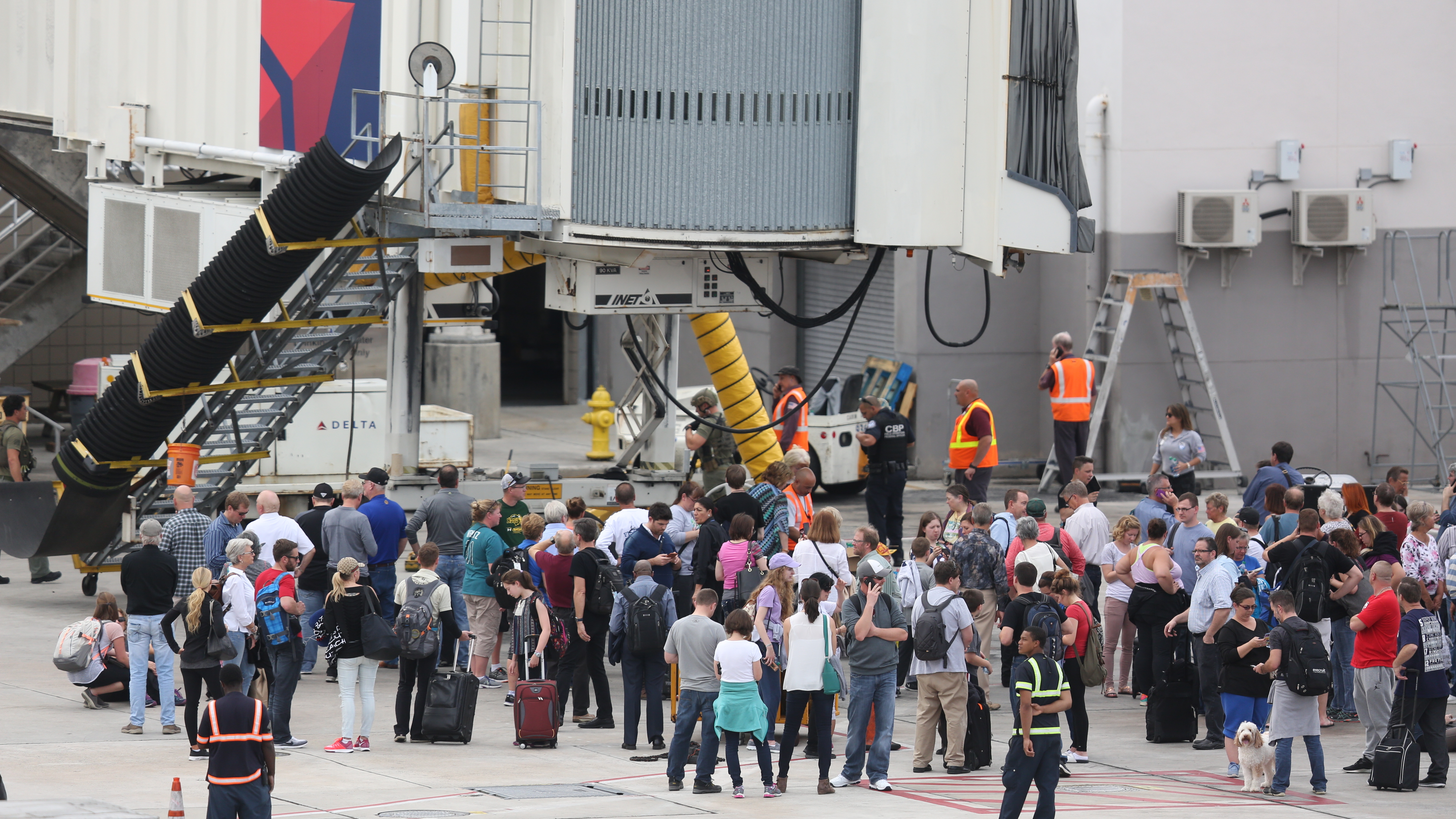 People waited on the tarmac of Fort Lauderdale-Hollywood International airport after a shooting caused Terminal 2 to be evacuated on January 6.