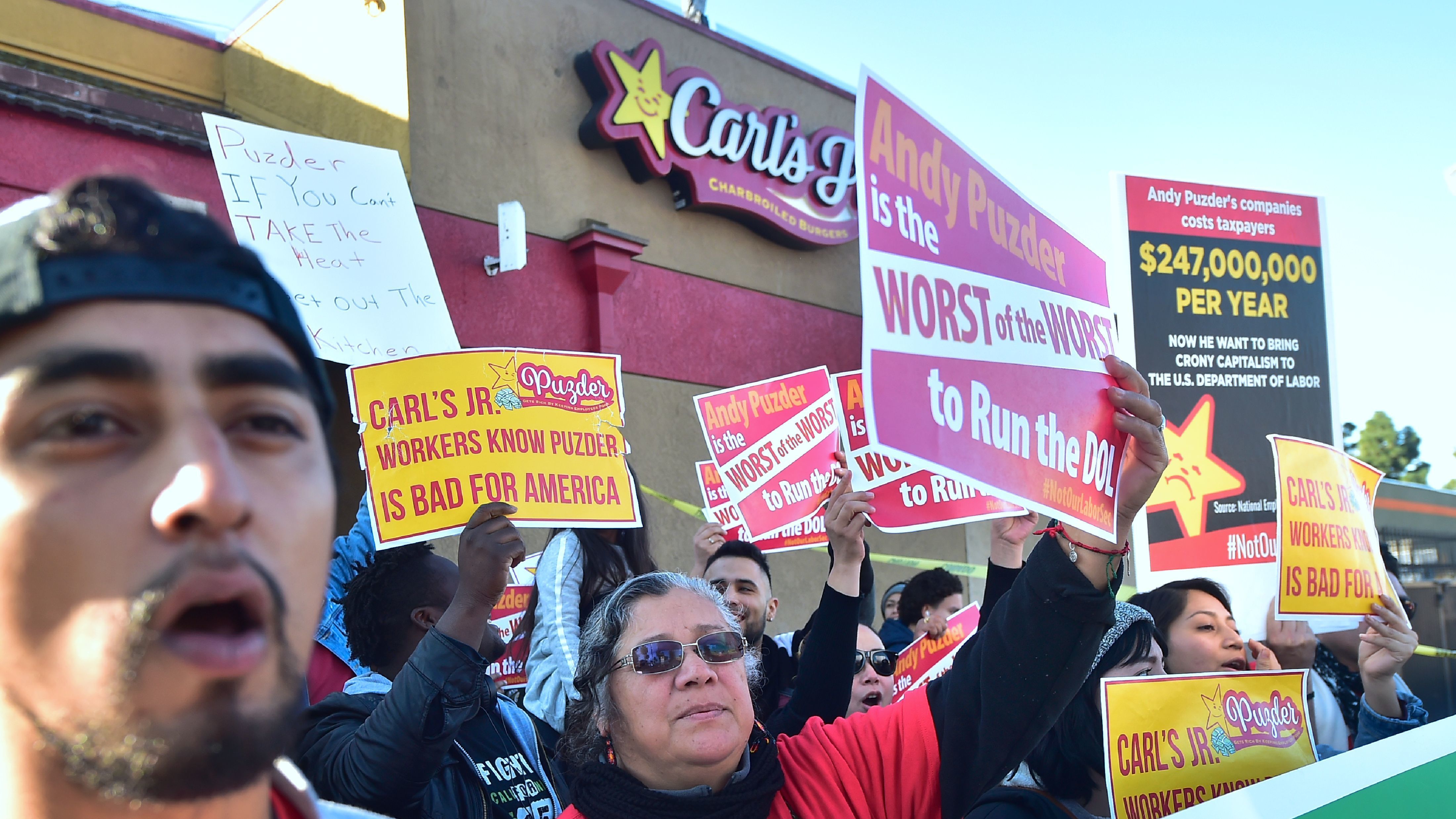 Fast-food workers in Los Angeles on Thursday protest against restaurant-chain mogul Andrew Puzder, who has been tapped as President Donald Trump's nominee for labor secretary. (AFP/Getty Images)