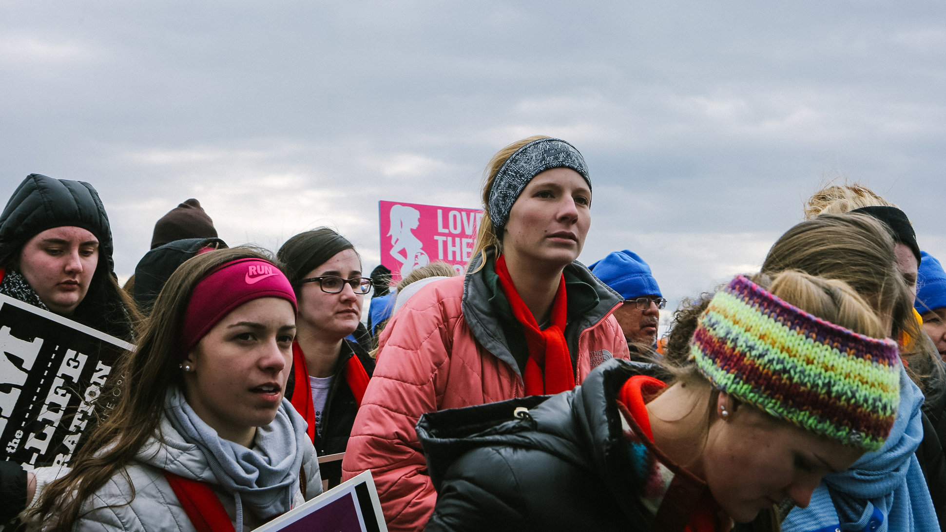 (Left) Groups of young people travelled from around the country to listen to speakers ranging from Vice President Mike Pence to Iowa Sen. Joni Ernst ahead of the march. (Right) Towson University student Edena Zeweie, 18, came with a friend. Her friend said that they were there to be "the voice for those who have no voice" and protest for Planned Parenthood to be defunded.