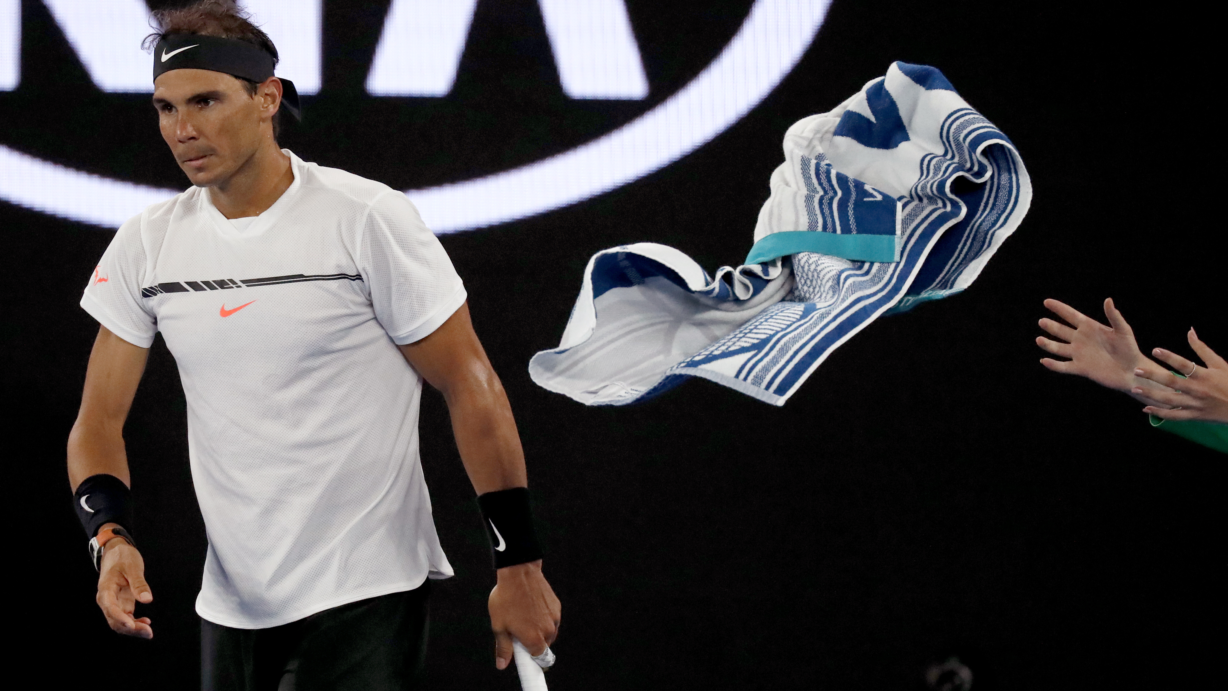 Rafael Nadal throws his towel to a ball boy during his semifinal against Bulgaria