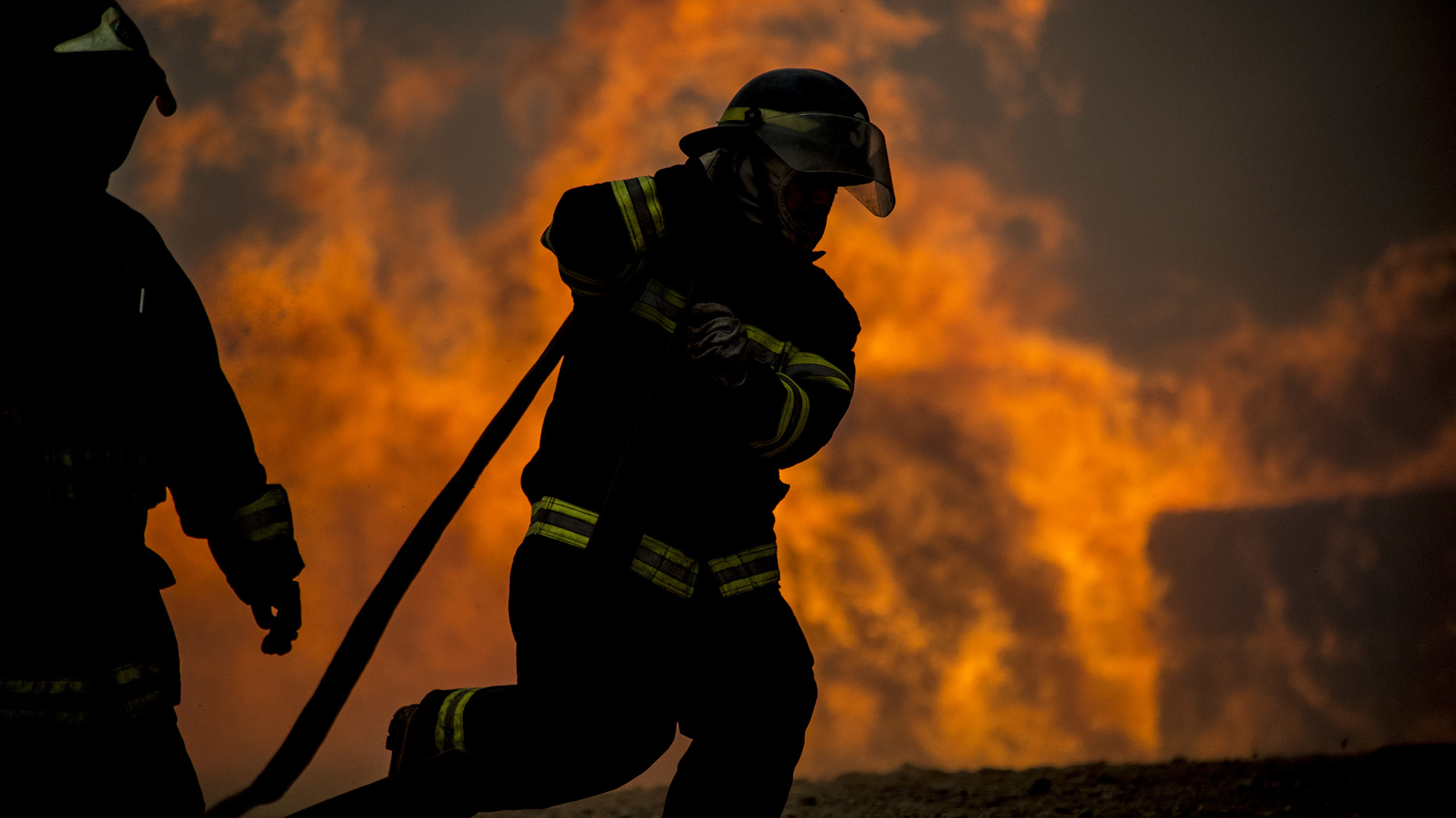 Firefighters work to put out a forest fire in Constitucion, Chile, on Thursday.