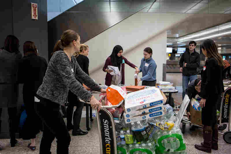 Volunteer attorneys at Washington Dulles International Airport in D.C. set up a temporary workstation near the baggage claim.