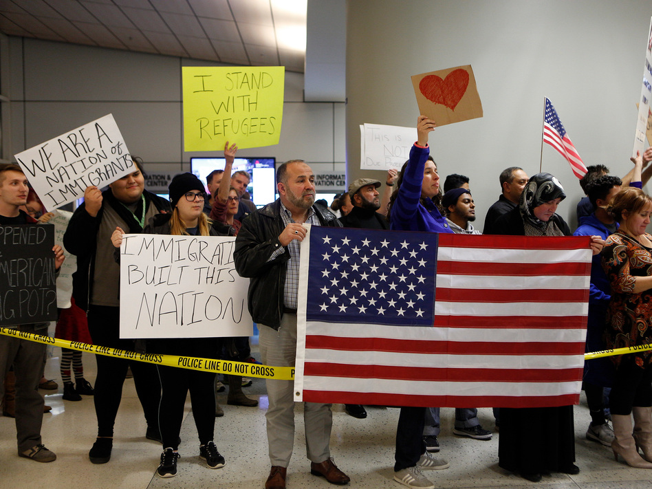 Demonstrators at Dallas-Fort Worth International Airport gather on Saturday to protest President Trump's executive order temporarily barred refugees and citizens of seven countries. (G. Morty Ortega/Getty Images)