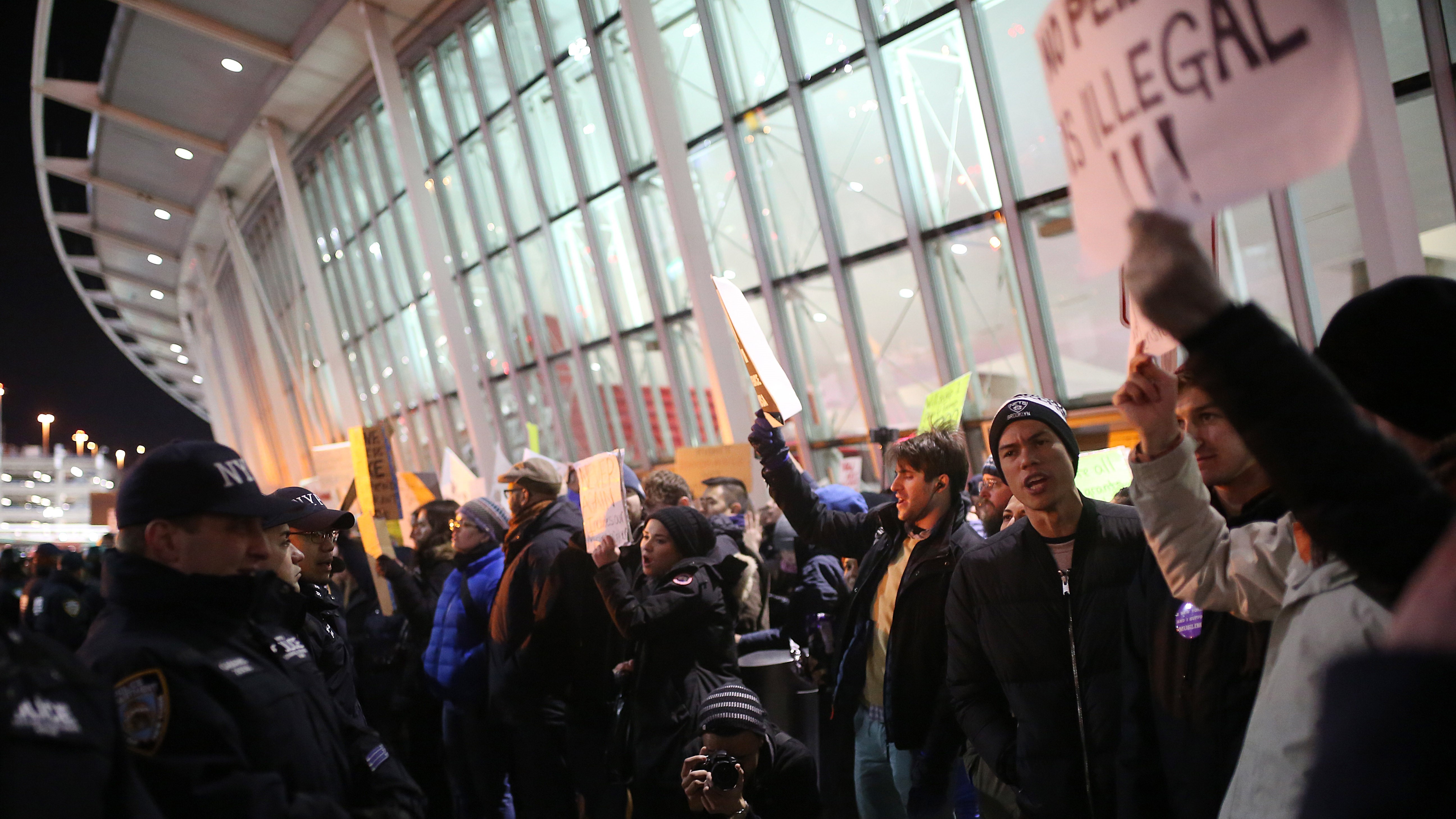 Activists stage a rally at John F. Kennedy International Airport in New York on Saturday against President Trump's order barring travelers from seven Muslim-majority countries for 90 days. (Getty Images)