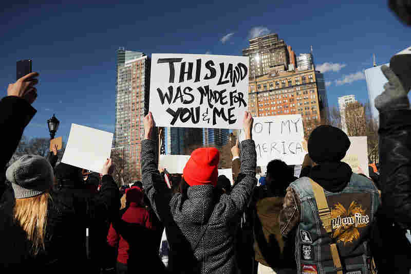 People attend an afternoon rally at Battery Park in New York City to protest President Trump's executive order.