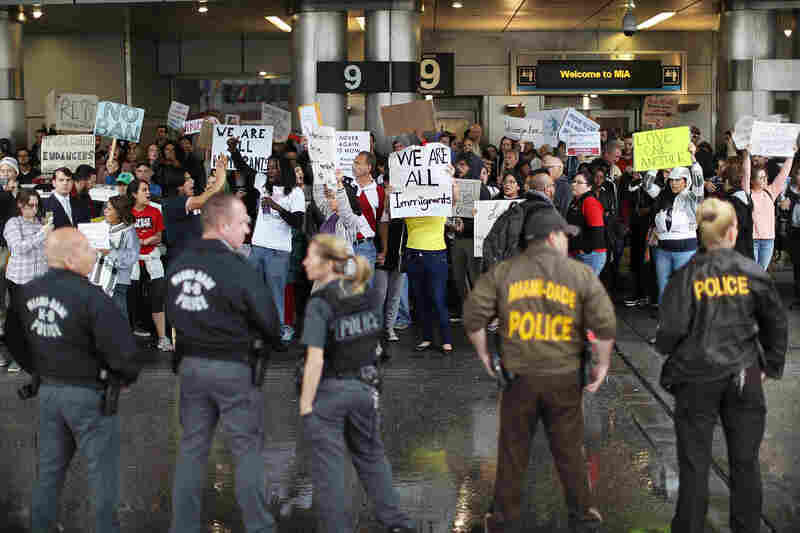 Protesters at the Miami International Airport rally against the president's executive order regarding immigration.
