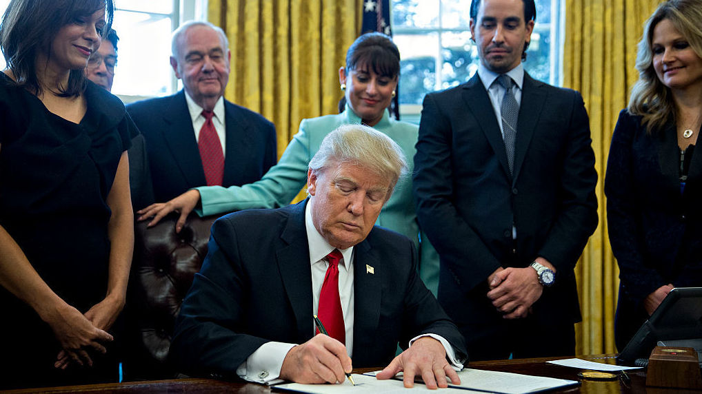 President Trump signs an executive action in the Oval Office of the White House on Monday in Washington, D.C., saying he will &quot;dramatically&quot; reduce small business regulations overall. (Getty Images)