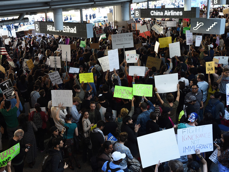 Protesters at Los Angeles International Airport rally Sunday against President Trump's executive order halting entry of refugees and others into the U.S. (Amanda Edwards/Getty Images)