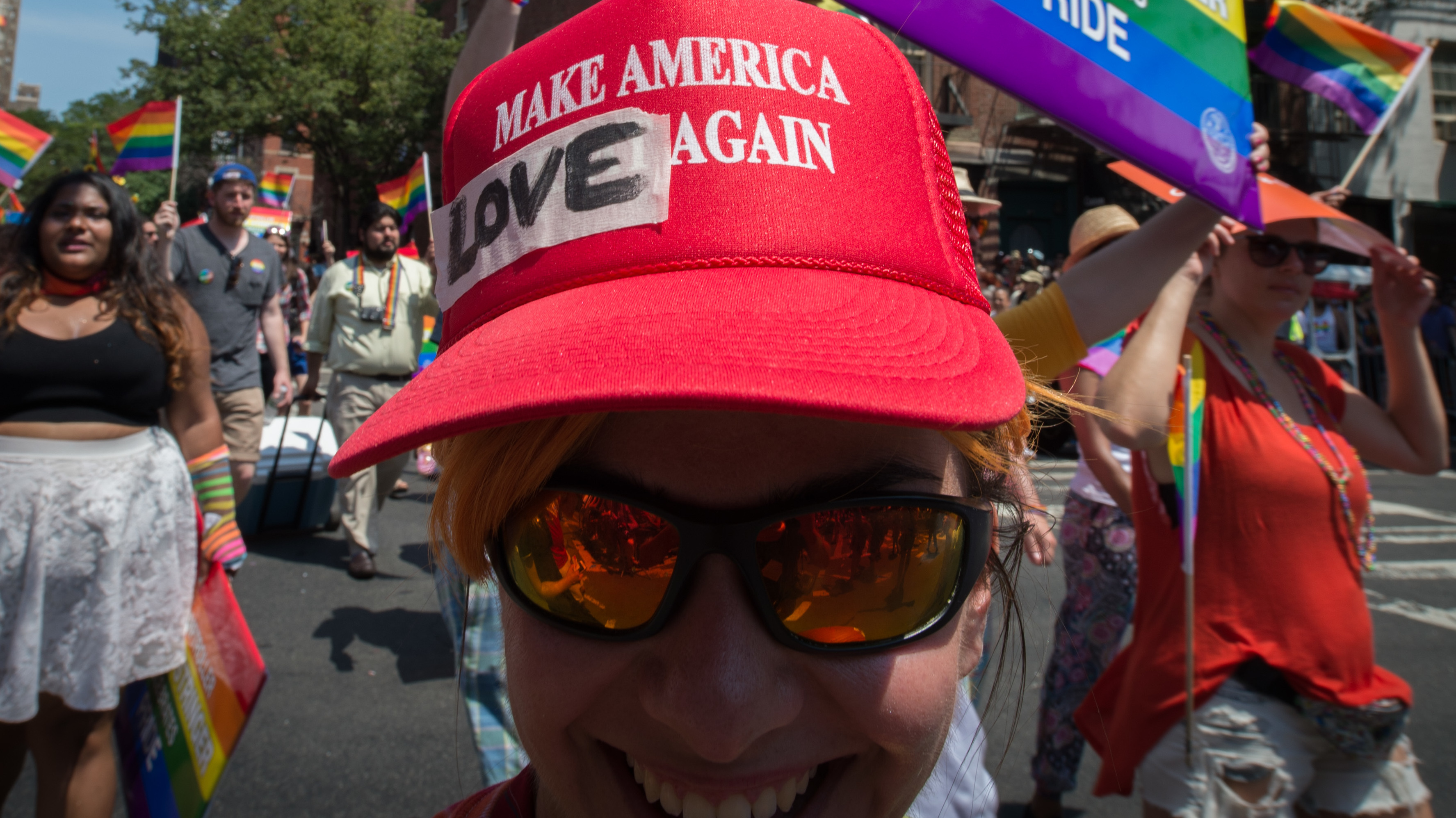 President Trump has decided to leave in place President Barack Obama's 2014 executive order protecting employees from anti-LGBTQ workplace discrimination while working for federal contractors. Here, a marcher in New York's Gay Pride march wears a modified version of a Trump campaign hat last summer. (AFP/Getty Images)